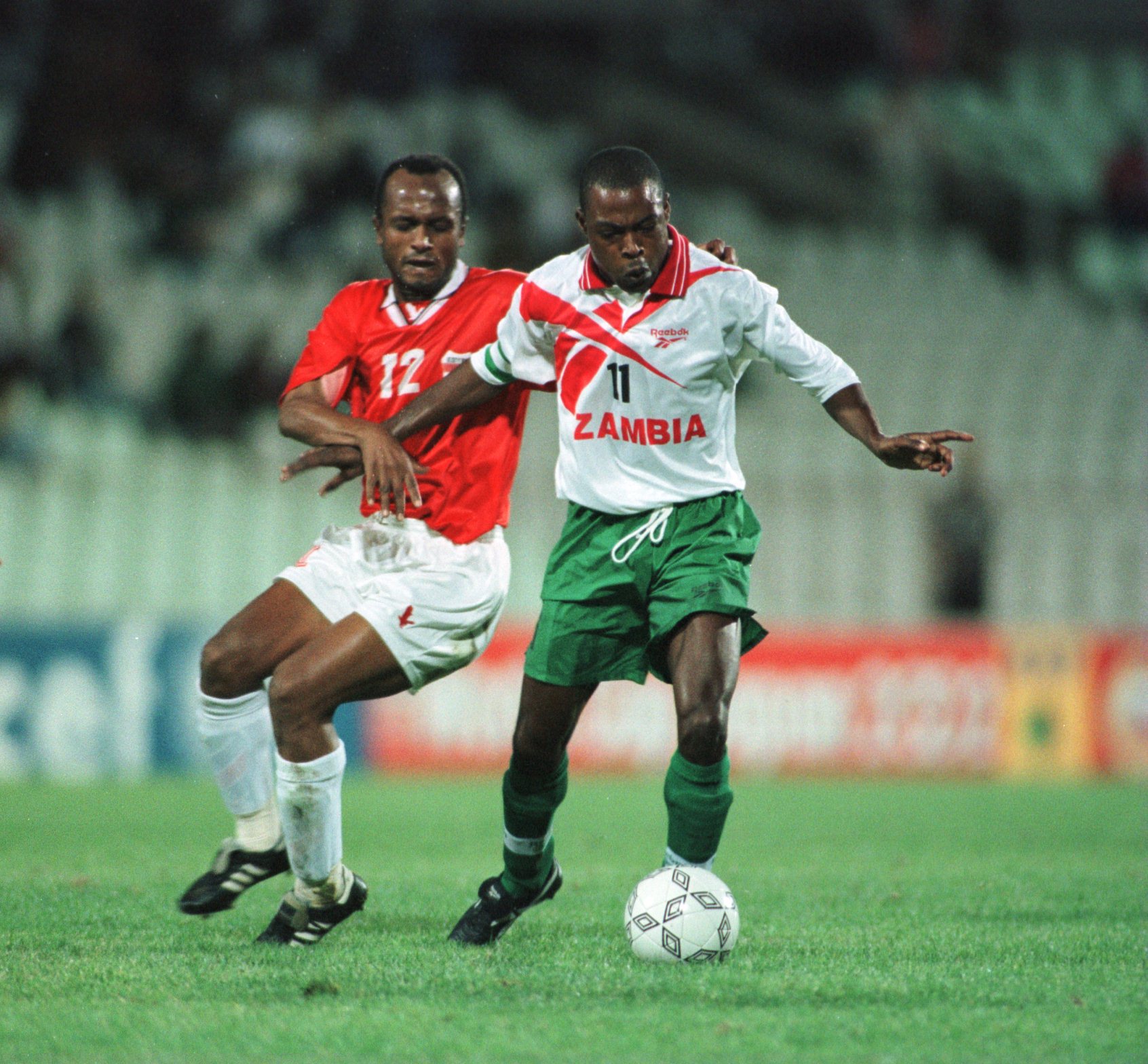 27 Jan1996.  Zambias captain Kalusha Bwayla  tussles with Ismail Youssef of Egypt during the quarter final of the African Cup of Nations . Mandatory Credit: Mark Thompson/ALLSPORT