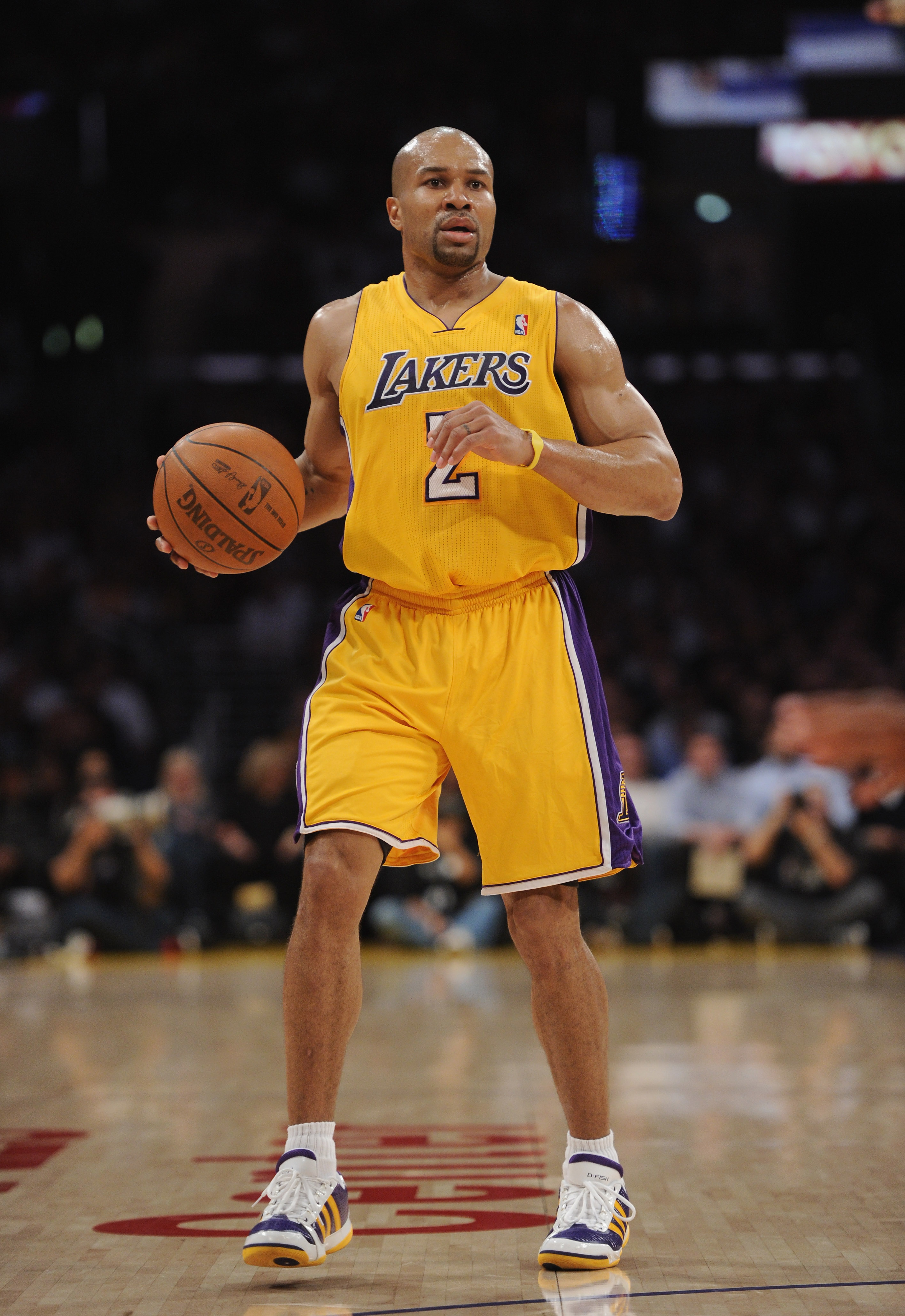 LOS ANGELES, CA - APRIL 12:  Derek Fisher #2 of the Los Angeles Lakers dribbles against the San Antonio Spurs at Staples Center on April 12, 2011 in Los Angeles, California.  NOTE TO USER: User expressly acknowledges and agrees that, by downloading and or