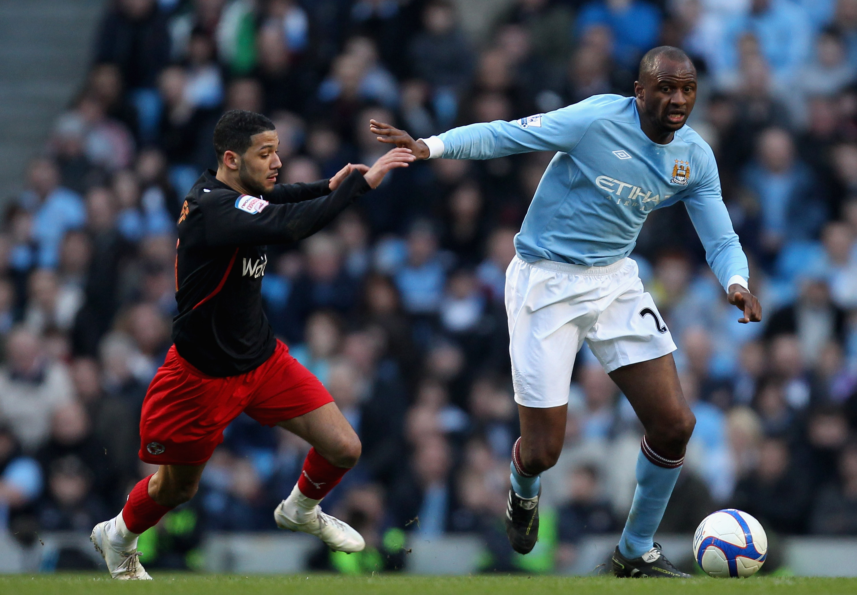 MANCHESTER, ENGLAND - MARCH 13:  Patrick Vieira of Manchester City holds off the challenge by Jobi McAnuff of Reading during the FA Cup sponsored by E.On Sixth Round match between Manchester City and Reading at the City of Manchester Stadium on March 13,