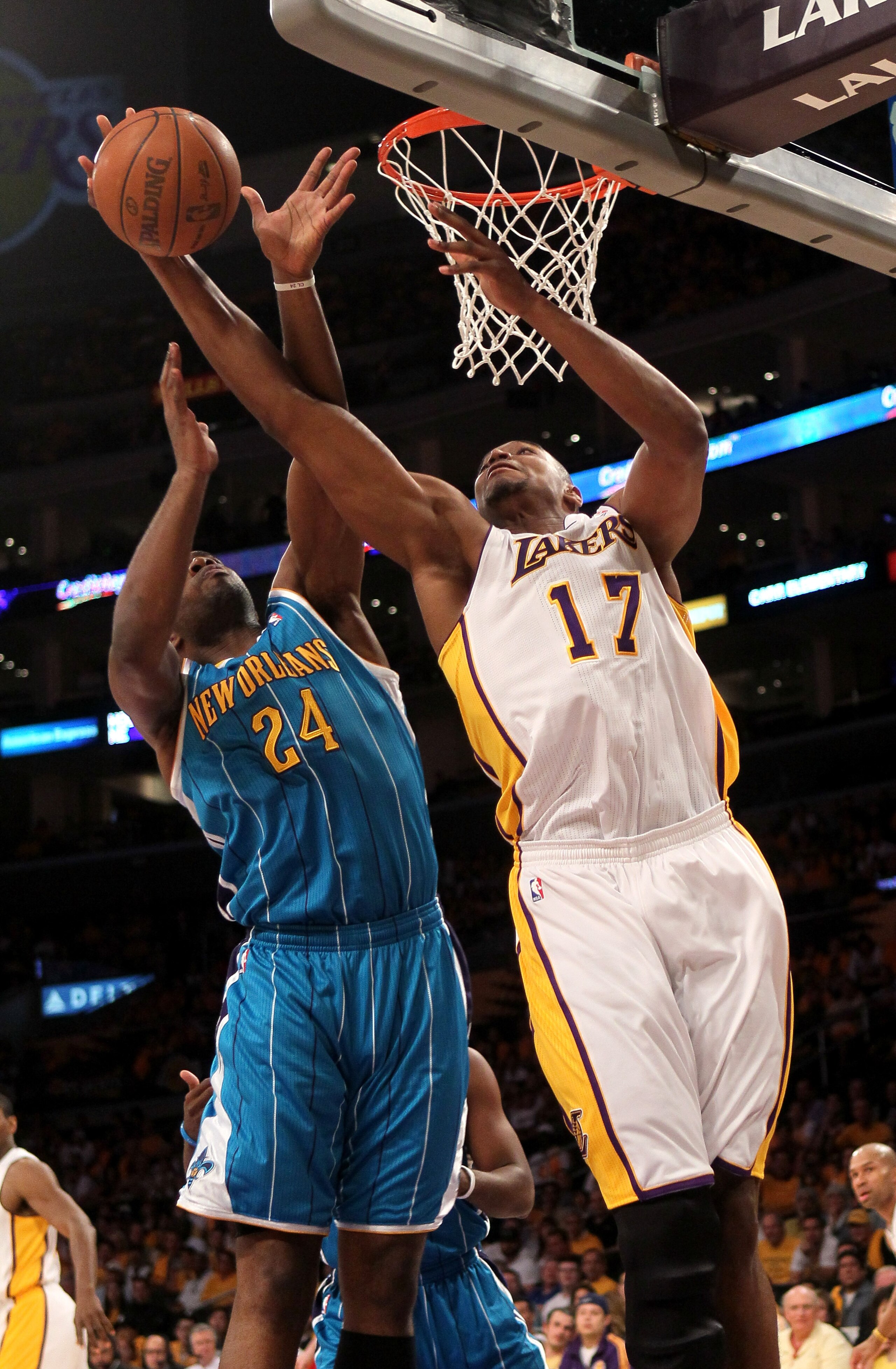 LOS ANGELES, CA - APRIL 17:  Andrew Bynum #17 of the Los Angeles Lakers grabs a rebound from carl Landry #24 of the New Orleans Hornets in Game One of the Western Conference Quarterfinals in the 2011 NBA Playoffs on April 17, 2011 at Staples Center in Los