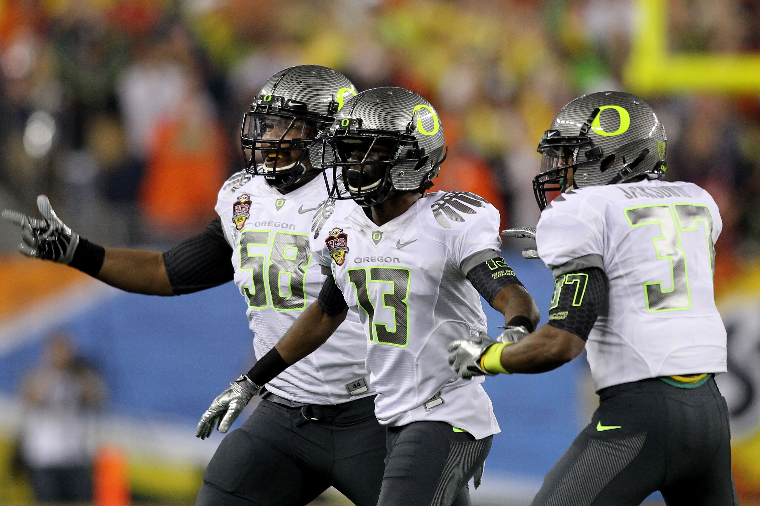 GLENDALE, AZ - JANUARY 10: Cliff Harris #13 of the Oregon Ducks celebrates his first quarter interception with teammates Drew Howell #50 and Talmadge Jackson III #37 against the Auburn Tigers during the Tostitos BCS National Championship Game at Universi GLENDALE, AZ - JANUARY 10: Cliff Harris #13 of the Oregon Ducks celebrates his first quarter interception with teammates Drew Howell #50 and Talmadge Jackson III #37 against the Auburn Tigers during the Tostitos BCS National Championship Game at Universi