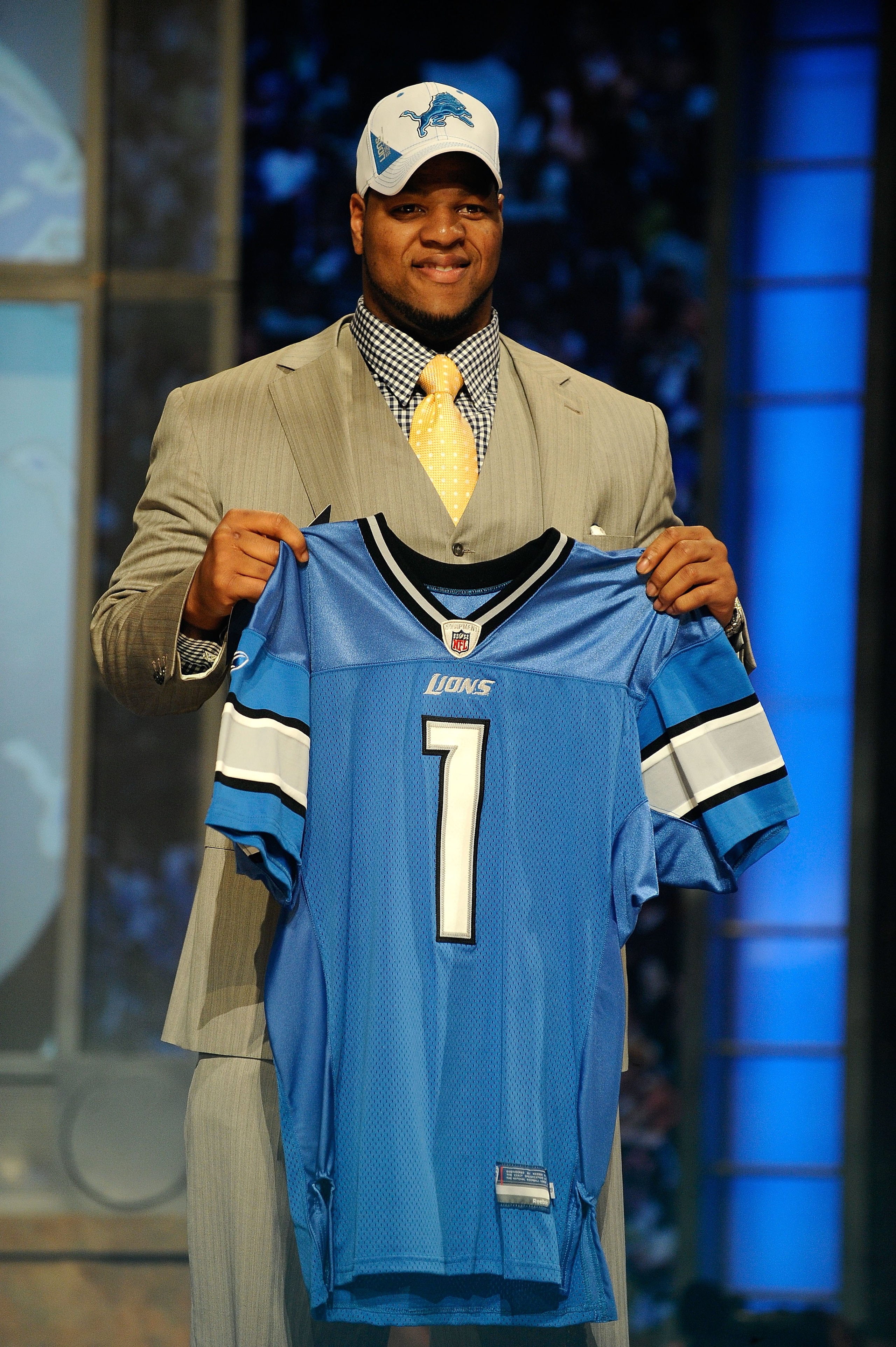 NEW YORK - APRIL 22:  Ndamukong Suh from the Nebraska Cornhuskers holds up a Detroit Lions jersey after Suh was selected by the Lions number 2 overall during the first round of the 2010 NFL Draft at Radio City Music Hall on April 22, 2010 in New York City