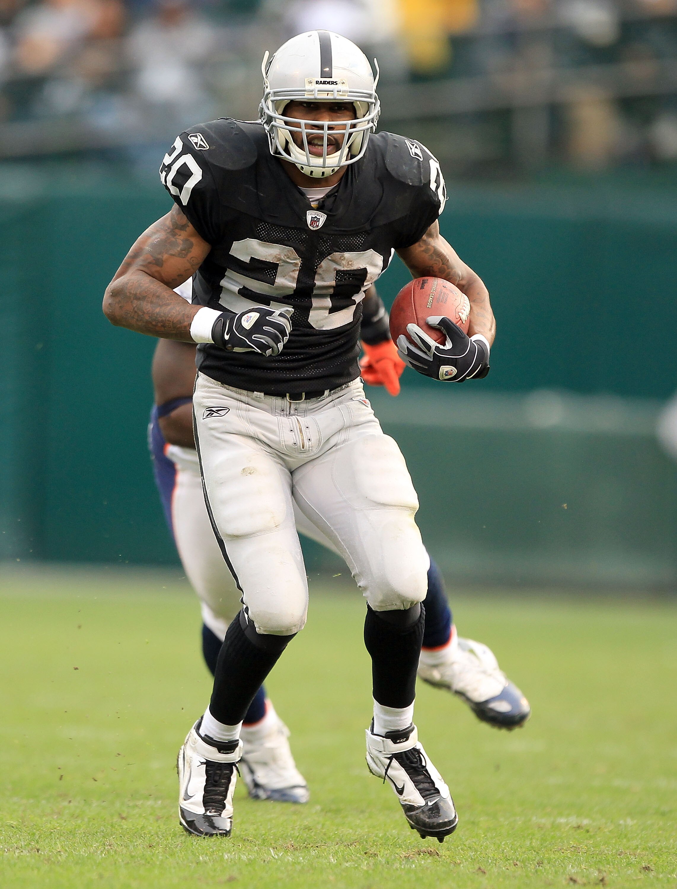OAKLAND, CA - DECEMBER 19: Darren McFadden #20 of the Oakland Raiders runs with the ball during their game against the Denver Broncos at Oakland-Alameda County Coliseum on December 19, 2010 in Oakland, California. (Photo by Ezra Shaw/Getty Images) OAKLAND, CA - DECEMBER 19: Darren McFadden #20 of the Oakland Raiders runs with the ball during their game against the Denver Broncos at Oakland-Alameda County Coliseum on December 19, 2010 in Oakland, California. (Photo by Ezra Shaw/Getty Images)