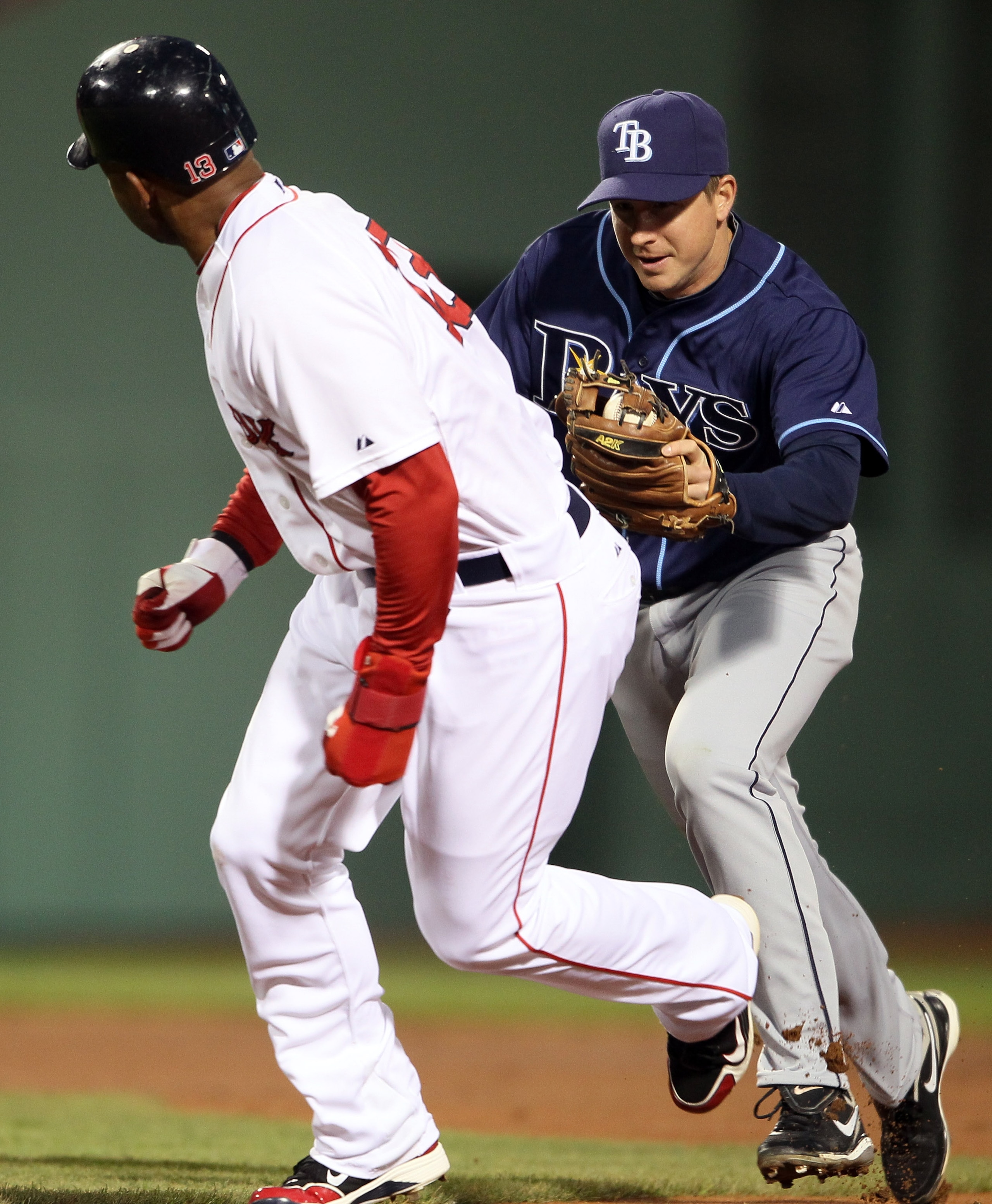 BOSTON, MA - APRIL 12: Carl Crawford #13 of the Boston Red Sox is tagged by Elliot Johnson #9 of the Tampa Bay Rays on April 12, 2011 at Fenway Park in Boston, Massachusetts. (Photo by Elsa/Getty Images) BOSTON, MA - APRIL 12: Carl Crawford #13 of the Boston Red Sox is tagged by Elliot Johnson #9 of the Tampa Bay Rays on April 12, 2011 at Fenway Park in Boston, Massachusetts. (Photo by Elsa/Getty Images)