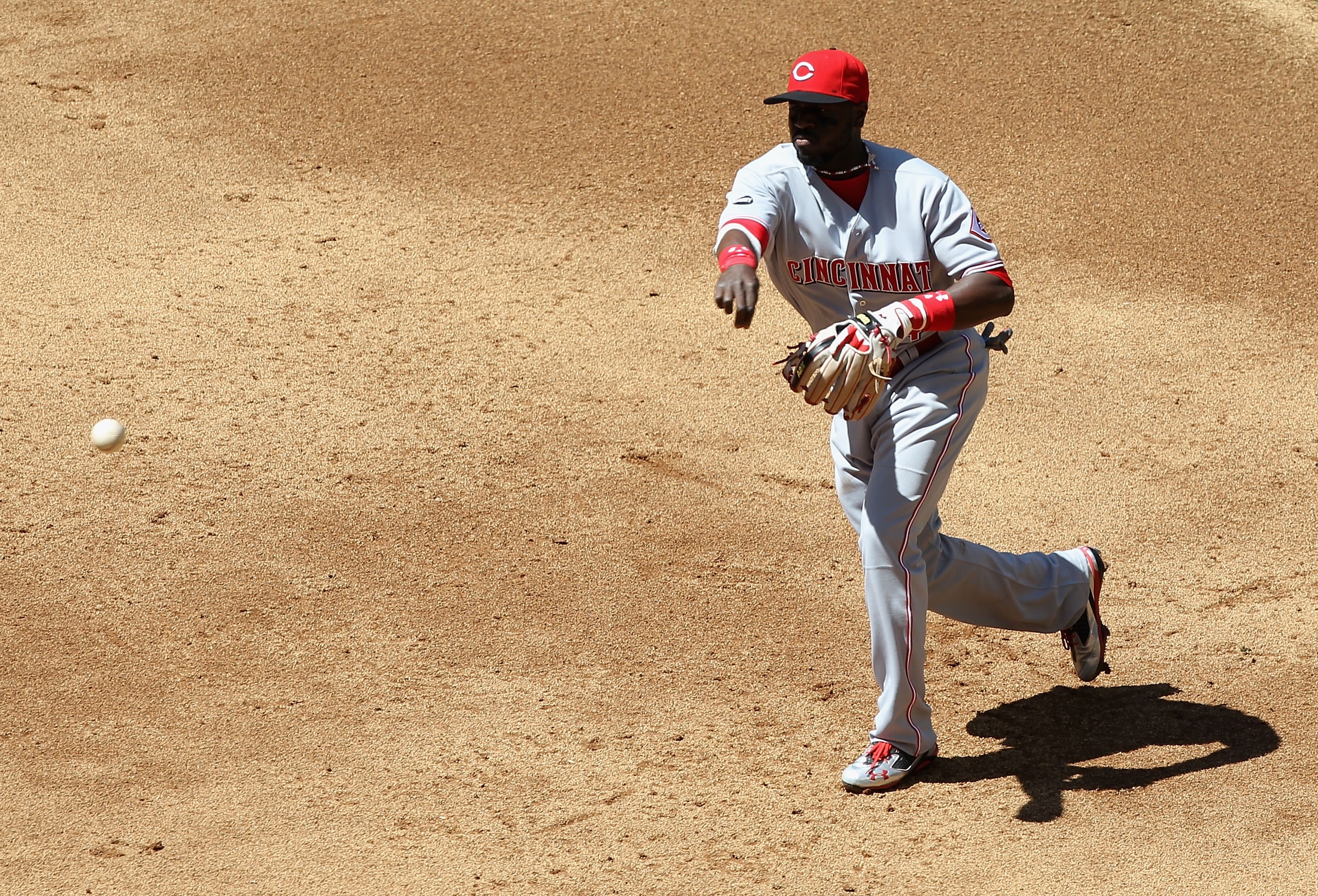 PHOENIX, AZ - APRIL 10: Iniflder Brandon Phillips #4 of the Cincinnati Reds fields a ground ball out against the Arizona Diamondbacks during the Major League Baseball game at Chase Field on April 10, 2011 in Phoenix, Arizona. The Diamondbacks defeated t PHOENIX, AZ - APRIL 10: Iniflder Brandon Phillips #4 of the Cincinnati Reds fields a ground ball out against the Arizona Diamondbacks during the Major League Baseball game at Chase Field on April 10, 2011 in Phoenix, Arizona. The Diamondbacks defeated t