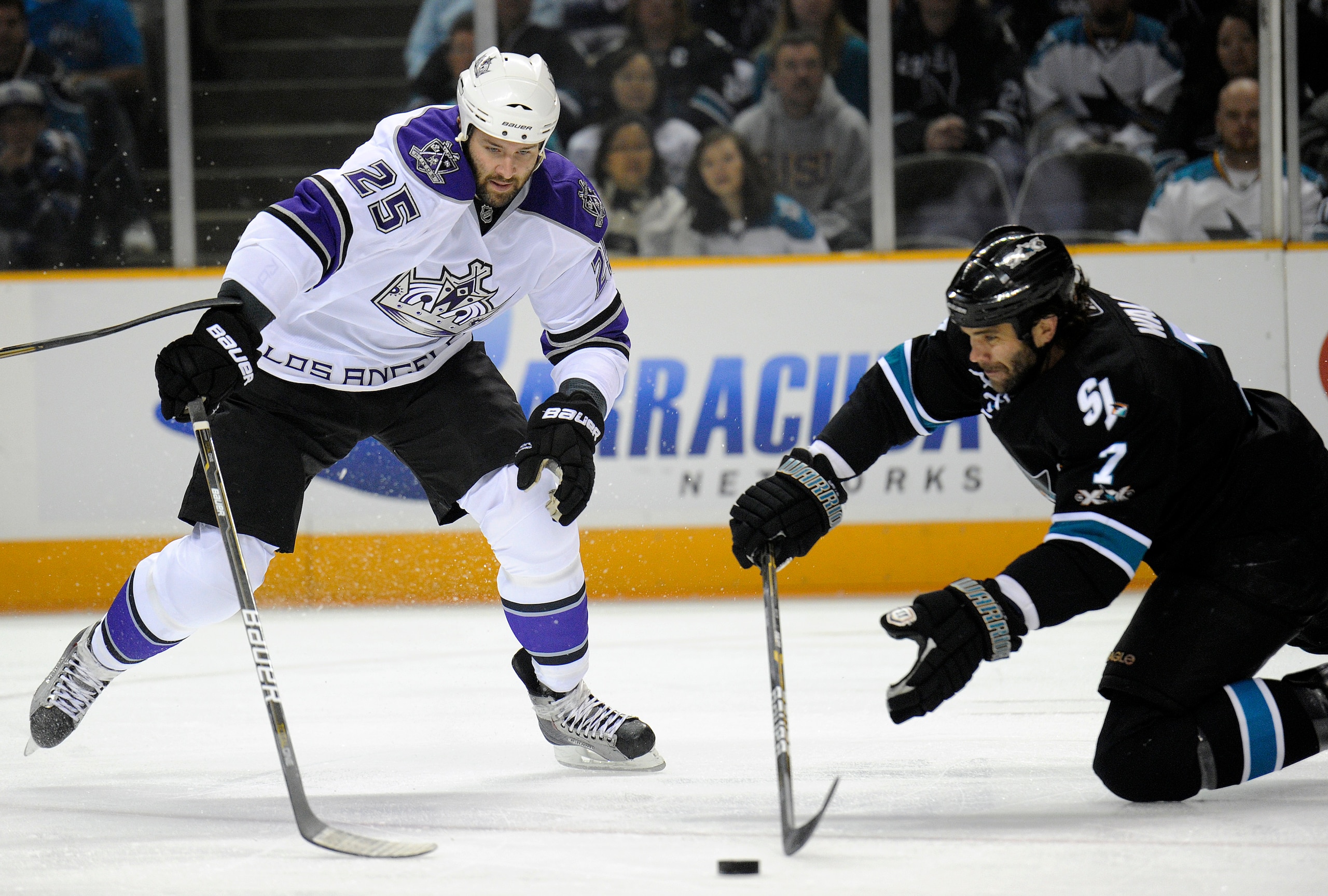 SAN JOSE, CA - APRIL 16: Niclas Wallin #7 of the San Jose Sharks knocks the puck away from Dustin Brown #25 of the Los Angeles Kings in Game Two of the Western Conference Quarterfinals during the 2011 NHL Stanley Cup Playoffs at the HP Pavilion on April 1 SAN JOSE, CA - APRIL 16: Niclas Wallin #7 of the San Jose Sharks knocks the puck away from Dustin Brown #25 of the Los Angeles Kings in Game Two of the Western Conference Quarterfinals during the 2011 NHL Stanley Cup Playoffs at the HP Pavilion on April 1