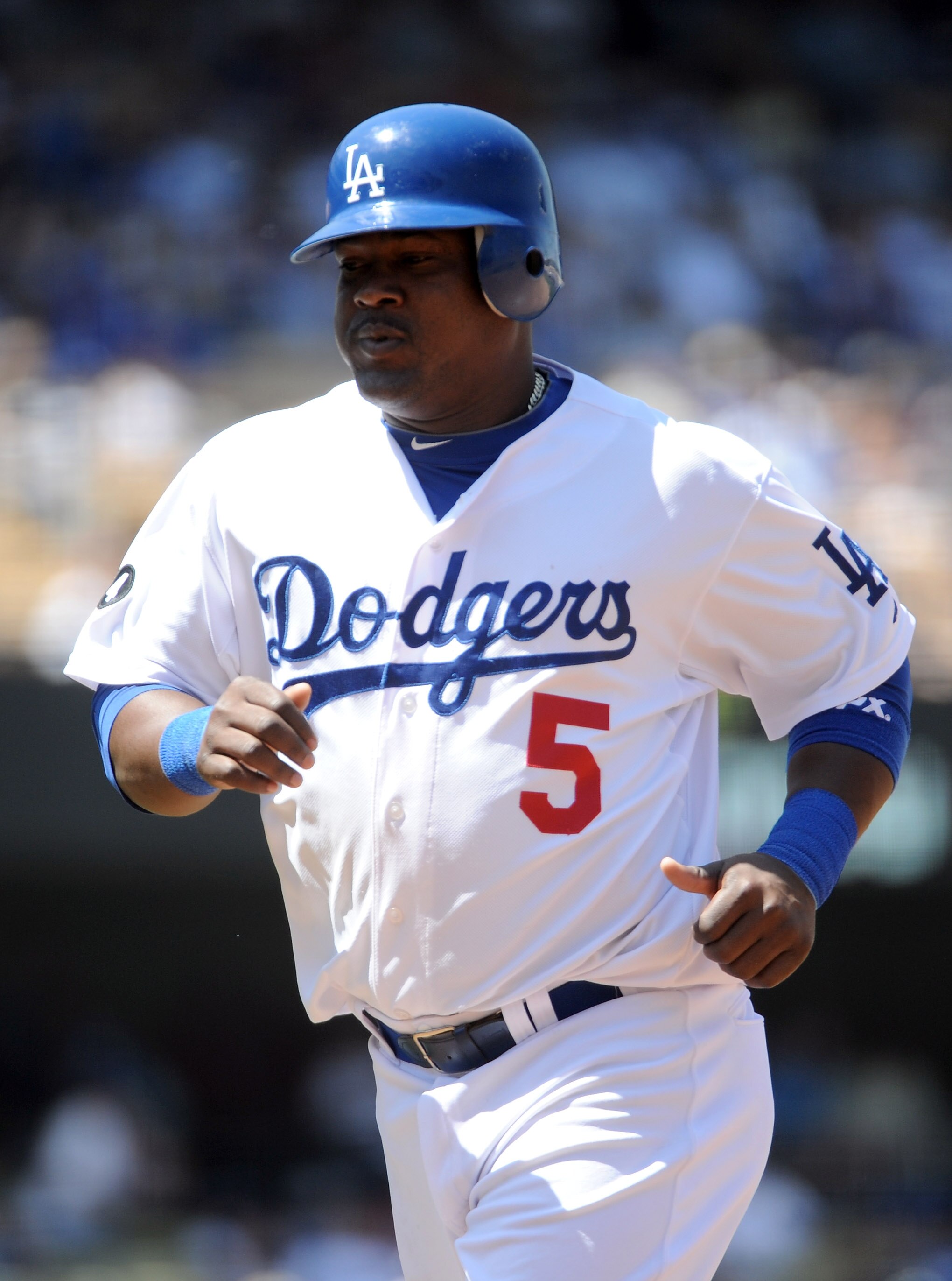 LOS ANGELES, CA - APRIL 17:  Juan Uribe #5 of the Los Angeles Dodgers leaves the field against the St Louis Cardinals at Dodger Stadium on April 17, 2011 in Los Angeles, California.  (Photo by Harry How/Getty Images)