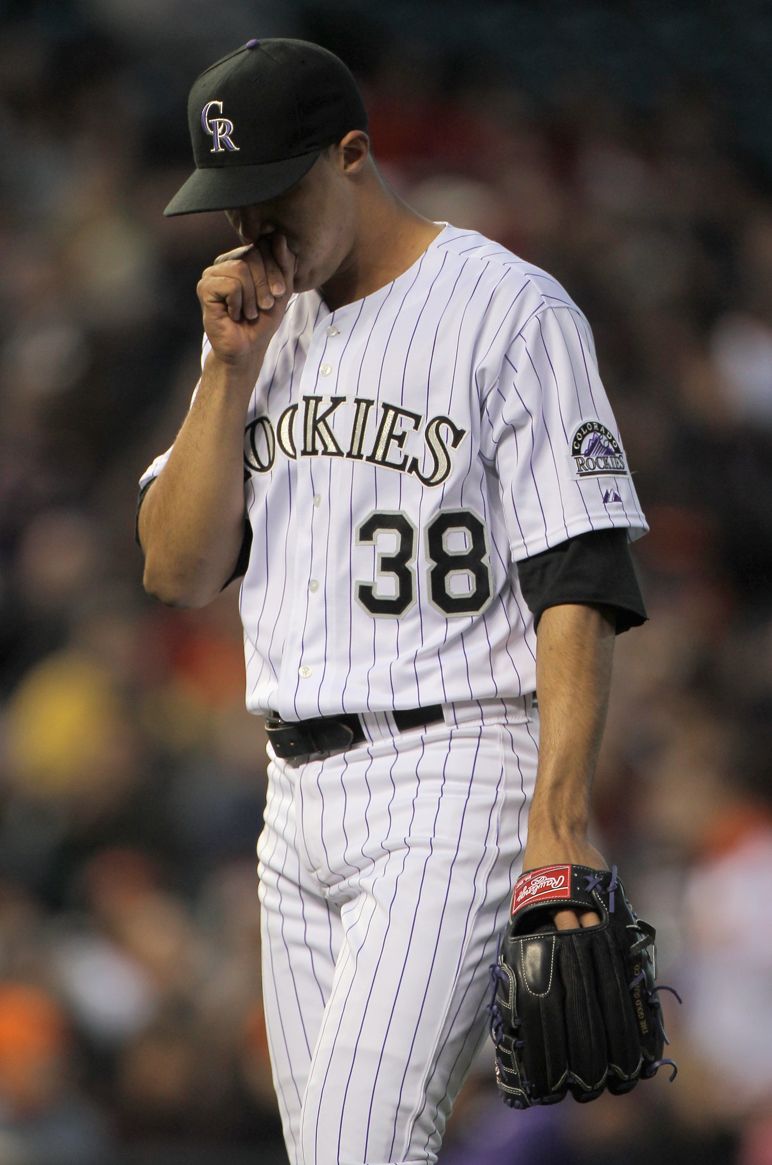 DENVER, CO - APRIL 19:  Starting pitcher Ubaldo Jimenez #38 of the Colorado Rockies heads for the dugout as he faces the San Francisco Giants at Coors Field on April 19, 2011 in Denver, Colorado.  (Photo by Doug Pensinger/Getty Images)