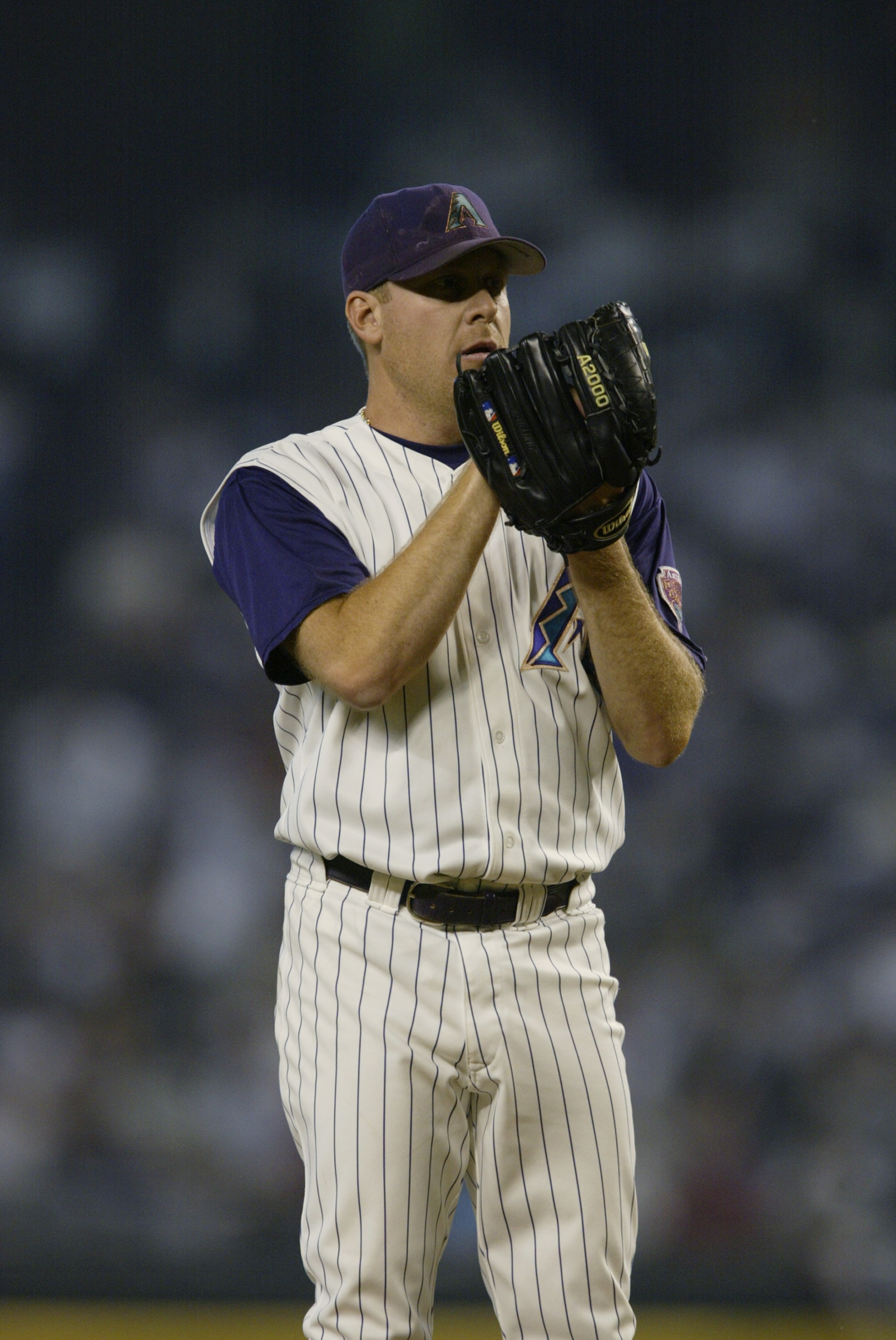 PHOENIX, AZ - OCTOBER 3:  Pitcher Curt Schilling of the Arizona Diamondbacks prepares to pitch the ball against the St. Louis Cardinals during game two of the National League Divisional Series at Bank One Ballpark on October 3, 2002 in Phoenix, Arizona.