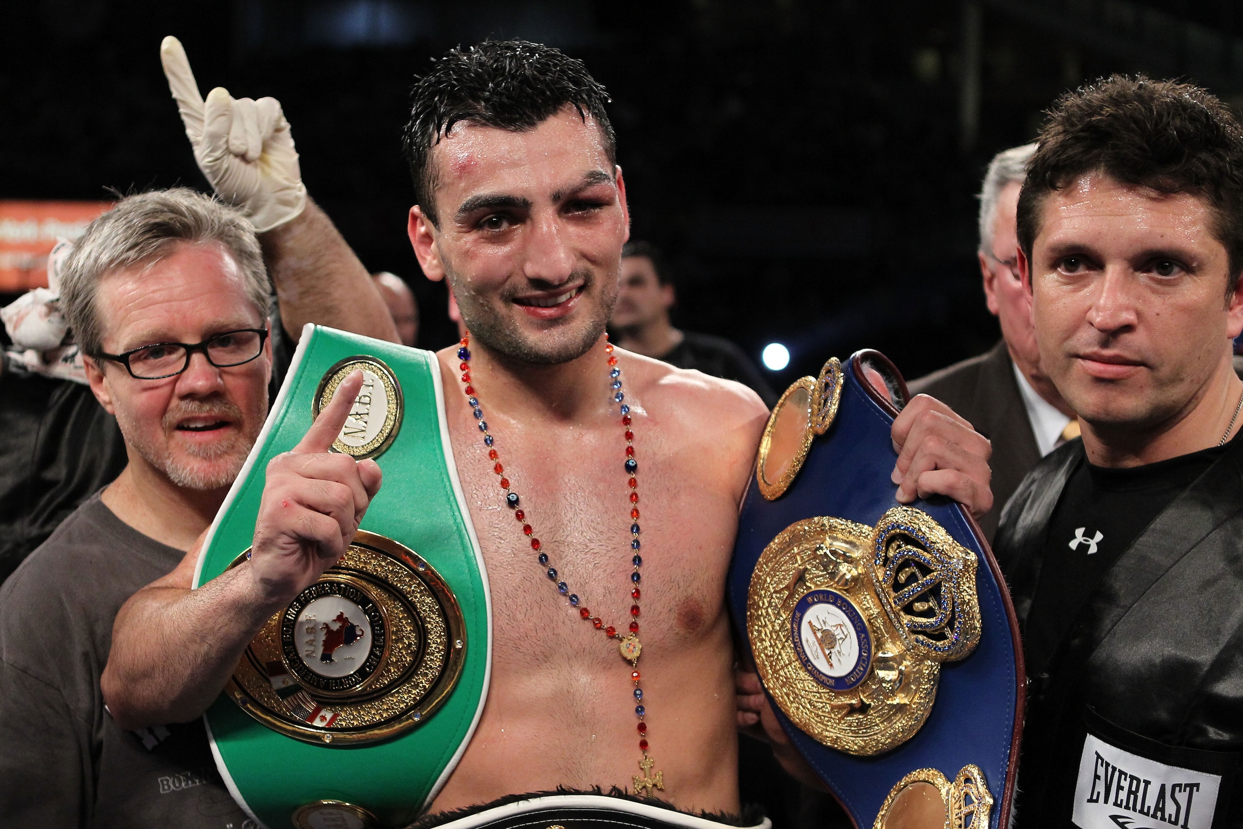 NEW YORK - JUNE 05:  Vanes Martirosyan (C) celebrates defeating Joe Green with his trainer Freddie Roach (L) after the NABF & NABO super welterweight fight on June 5, 2010 at Yankee Stadium in the Bronx borough of New York City. Matirosyan wins by unanimo