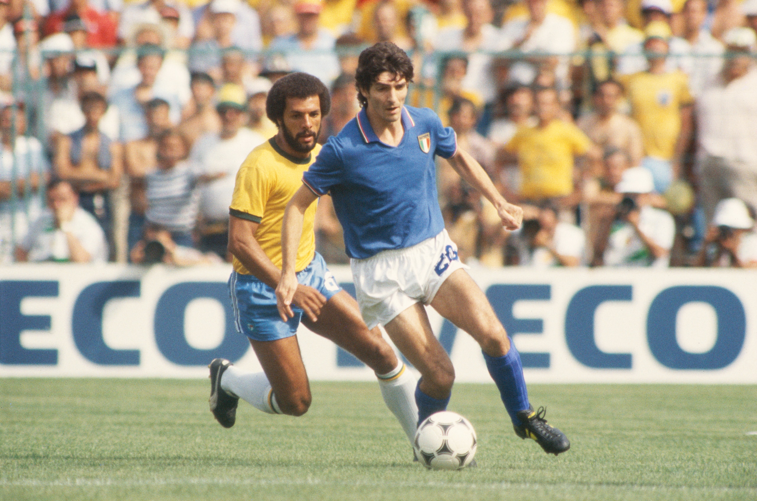 BARCELONA, SPAIN - JULY 5:  Paolo Rossi of Italy shields the ball from Junior of Brazil during the World Cup Round Two, Group  Three match between Brazil and Italy held at the Sarria Stadium, Barcelona, Spain on July 5, 1982. Italy won the match 3-2. (Pho