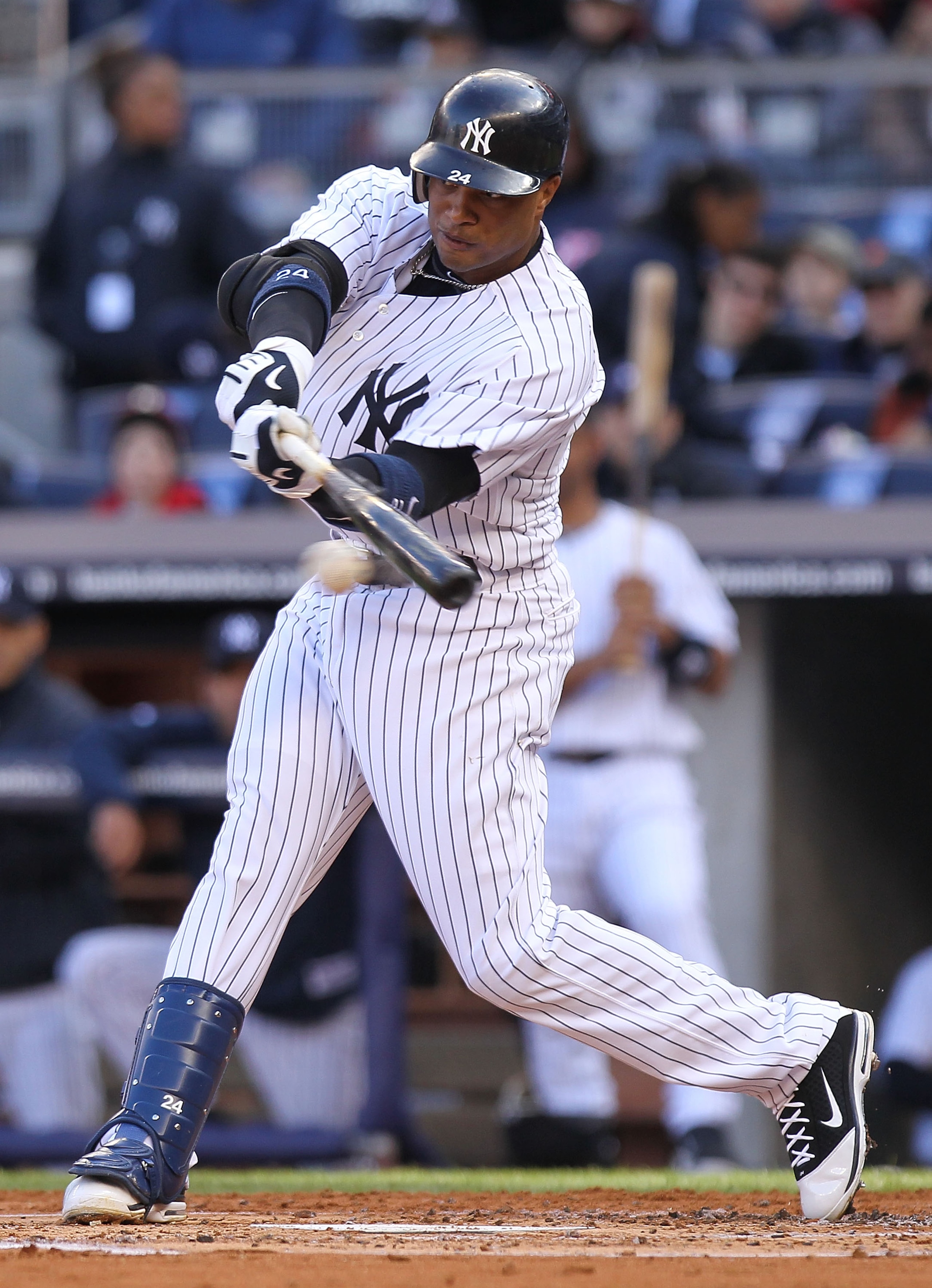 NEW YORK, NY - APRIL 02: Robinson Cano #24 of the New York Yankees hits an RBI single against the Detroit Tigers at Yankee Stadium on April 2, 2011 in the Bronx borough of New York City.  (Photo by Nick Laham/Getty Images)