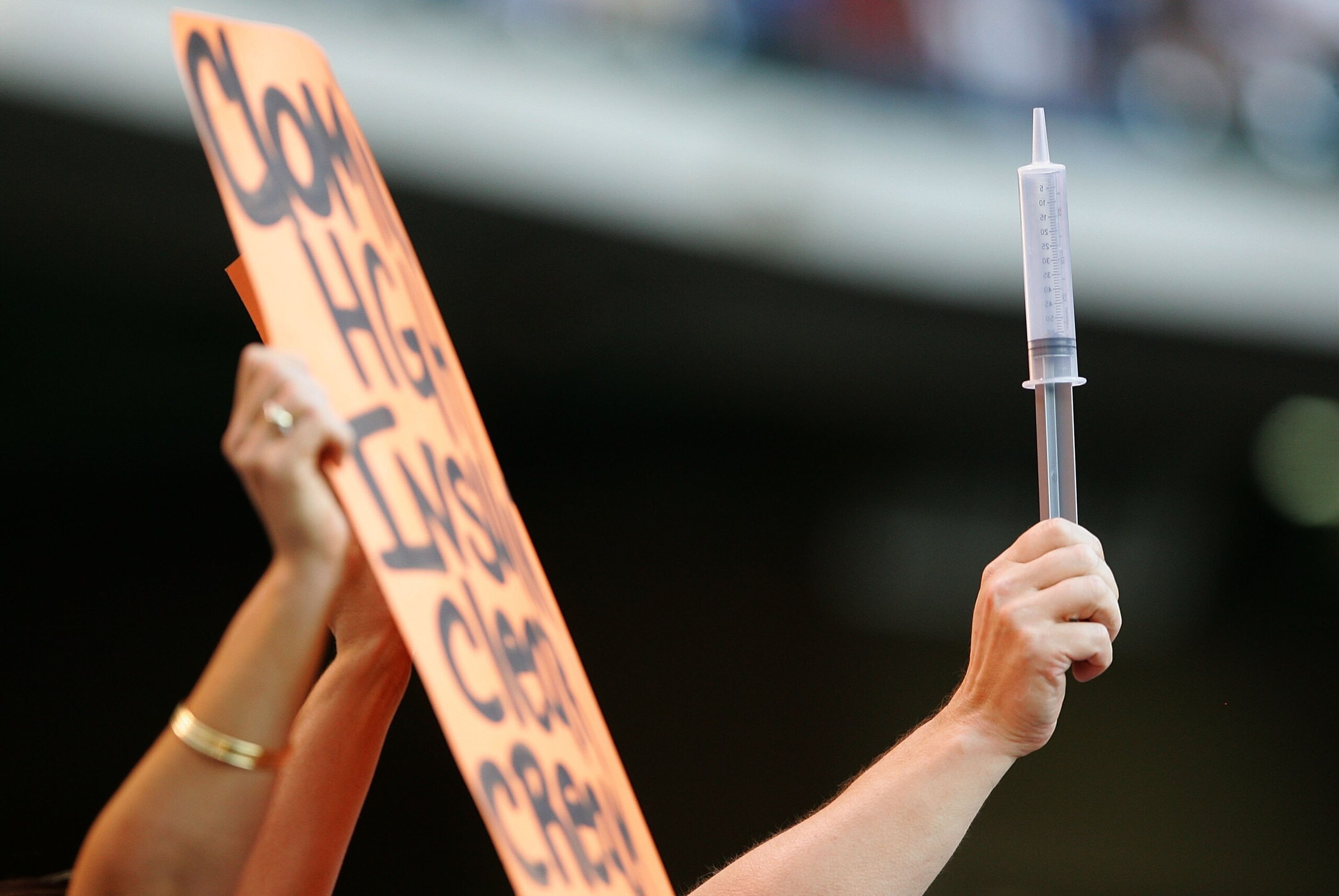 HOUSTON - MAY 16:  A fan holds a sign and a syringe for Barry Bonds #25 of the San Francisco Giants during a game against the Houston Astros on May 16, 2006 at Minute Maid Park in Houston, Texas.  (Photo by Jed Jacobsohn/Getty Images)