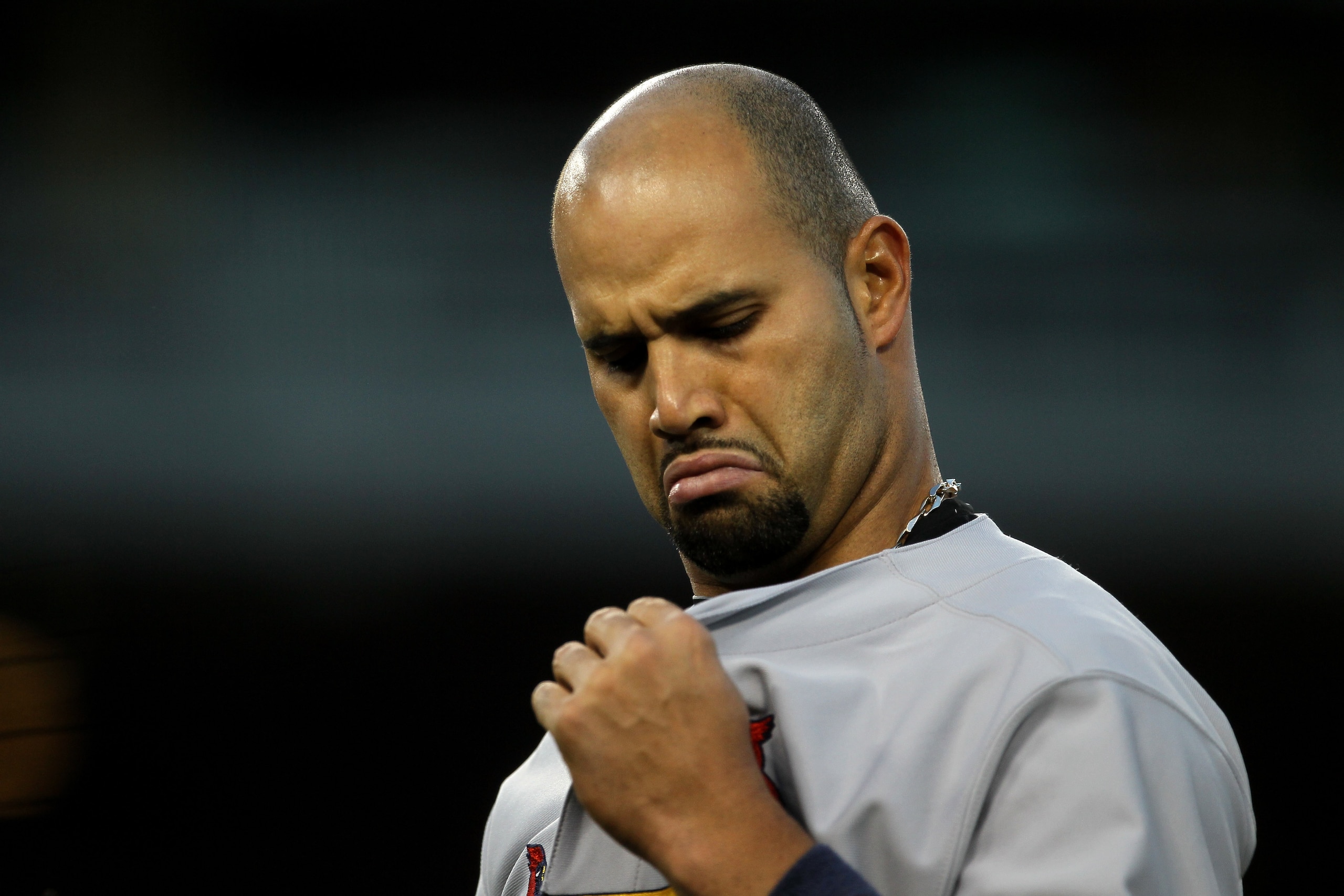 LOS ANGELES - APRIL 14:  Albert Pujols #5 of the St Louis Cardinals looks at his jersey in the game with the Los Angeles Dodgers on April 14, 2011 at Dodger Stadium in Los Angeles, California.  (Photo by Stephen Dunn/Getty Images)