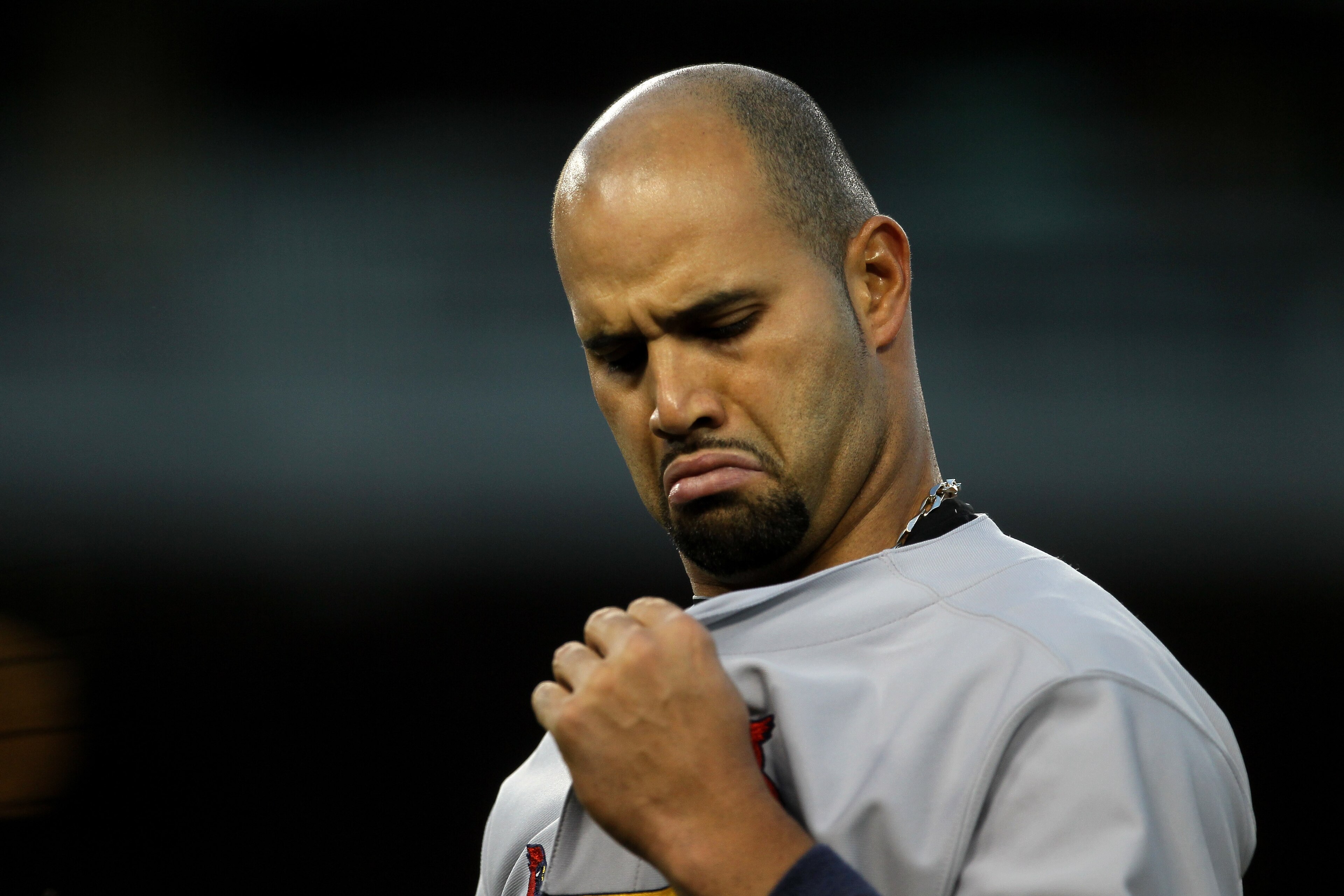 LOS ANGELES - APRIL 14:  Albert Pujols #5 of the St Louis Cardinals looks at his jersey in the game with the Los Angeles Dodgers on April 14, 2011 at Dodger Stadium in Los Angeles, California.  (Photo by Stephen Dunn/Getty Images)
