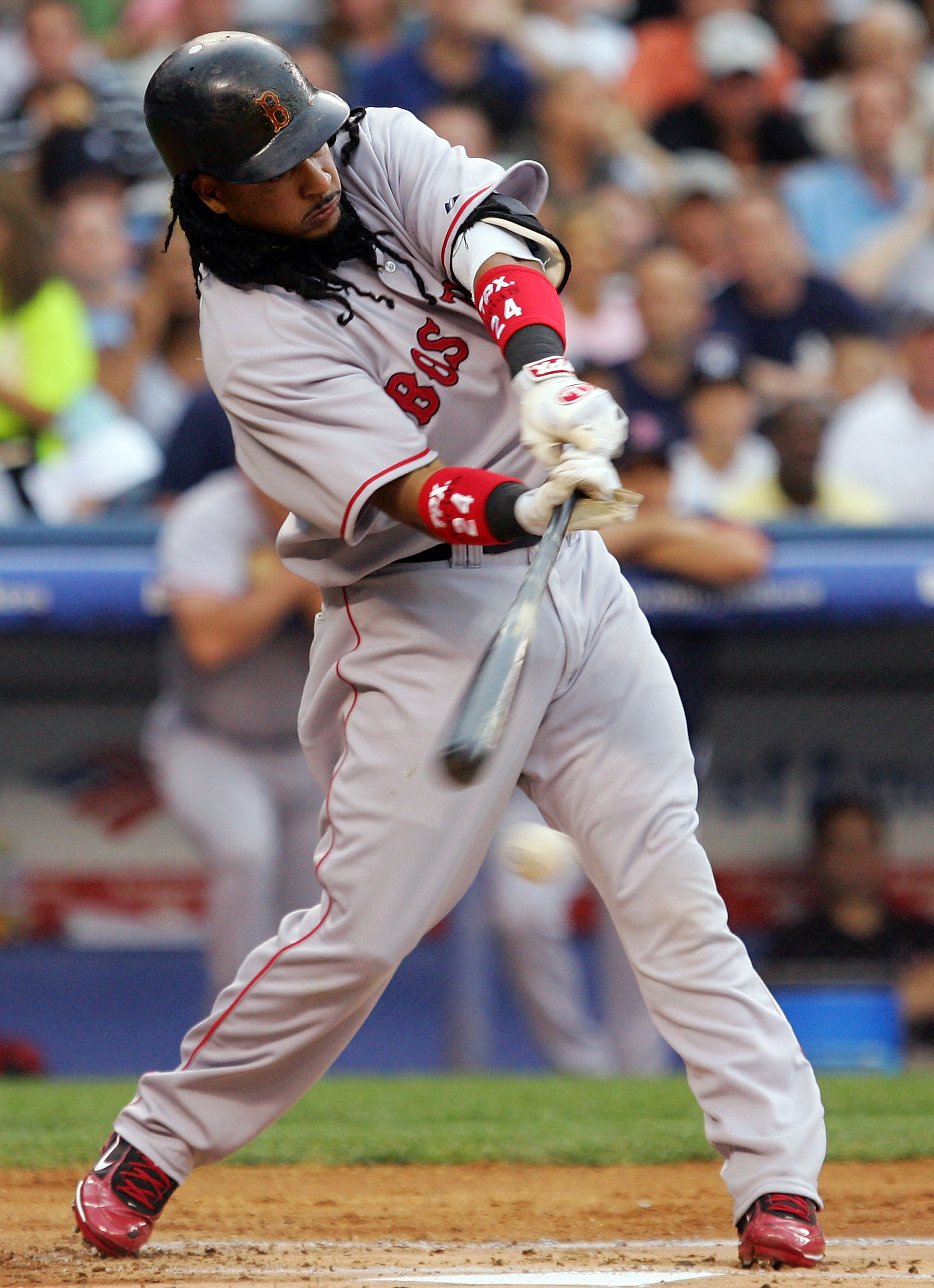 NEW YORK - JULY 03:  Manny Ramirez #24 of the Boston Red Sox hits into a run scoring fielders choice in the first inning against the New York Yankees on July 3, 2008 at Yankee Stadium in the Bronx borough of New York City.  (Photo by Jim McIsaac/Getty Ima