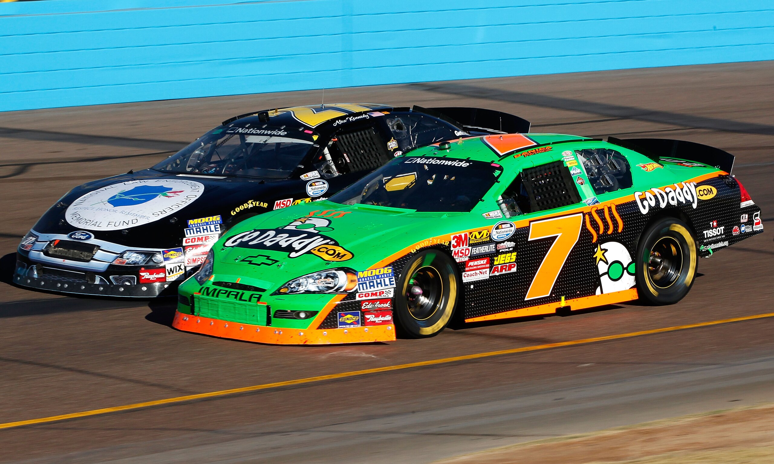 AVONDALE, AZ - NOVEMBER 13: Danica Patrick drives the #7 GoDaddy.com Chevrolet side by each with Alex Kennedy, driver of the #27 Lawmemorial.com Ford during the NASCAR Nationwide Series WYPALL 200 at Phoenix International Raceway on November 13, 2010 in AVONDALE, AZ - NOVEMBER 13: Danica Patrick drives the #7 GoDaddy.com Chevrolet side by each with Alex Kennedy, driver of the #27 Lawmemorial.com Ford during the NASCAR Nationwide Series WYPALL 200 at Phoenix International Raceway on November 13, 2010 in