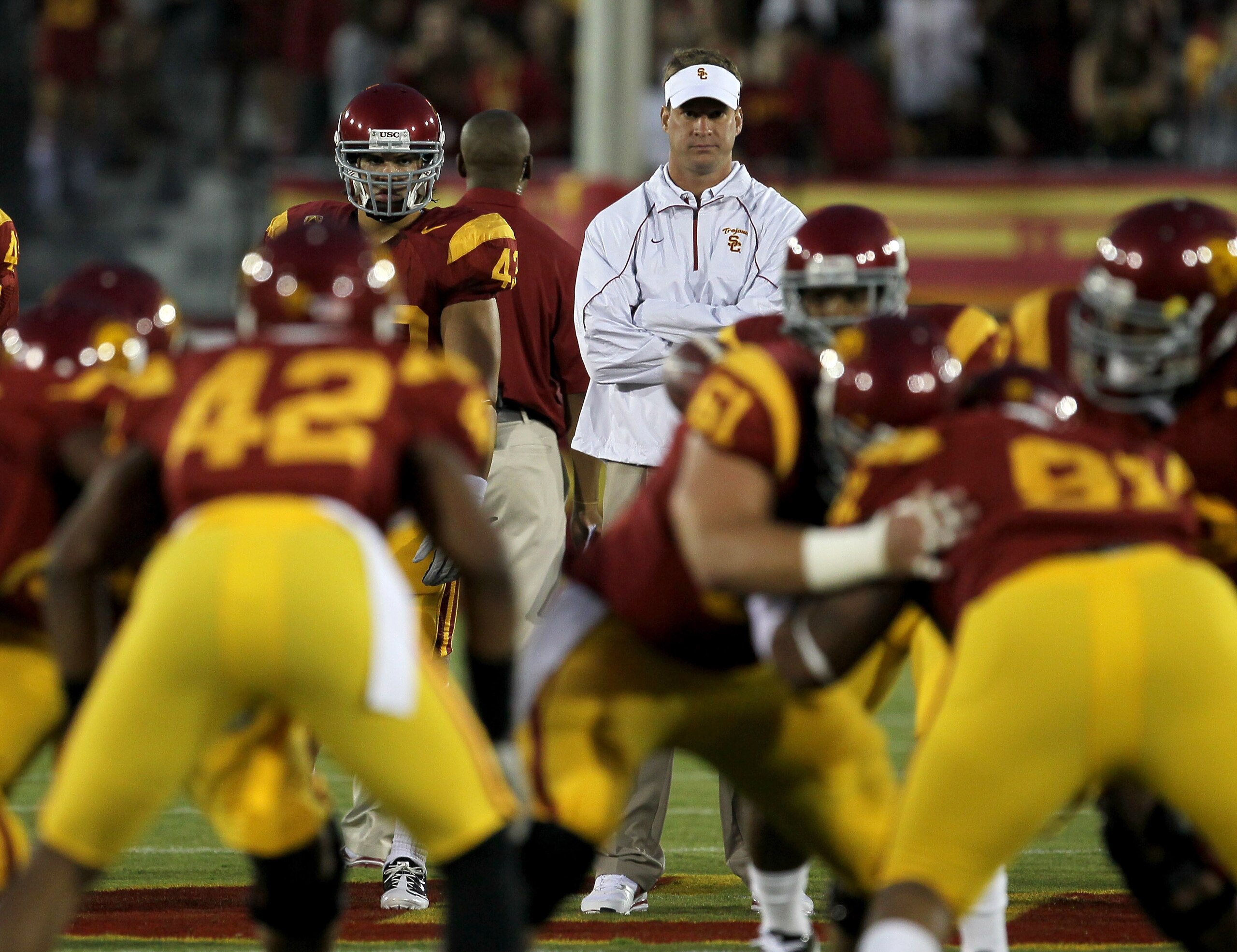 LOS ANGELES - SEPTEMBER 11:  Head coach Lane Kiffin watches the USC Trojans warm up for their game with the Virginia Cavaliers at Los Angeles Memorial Coliseum on September 11, 2010 in Los Angeles, California. (Photo by Stephen Dunn/Getty Images)