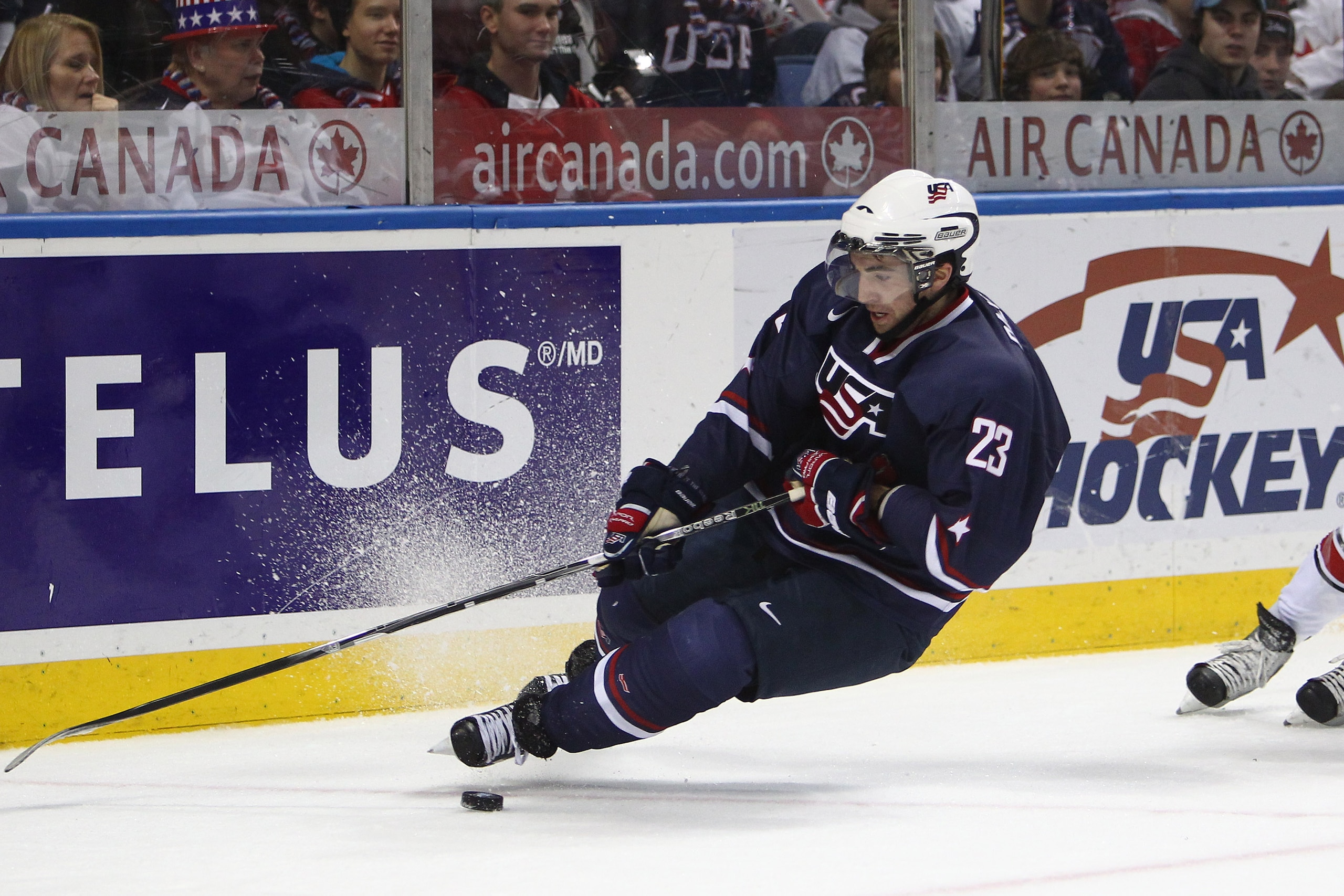 BUFFALO, NY - DECEMBER 31: Forward Kyle Palmieri #23 of USA loses his footing and falls during the 2011 IIHF World U20 Championship game between USA and Switzerland on December 31, 2010 at HSBC Arena in Buffalo, New York. (Photo by Tom Szczerbowski/Getty