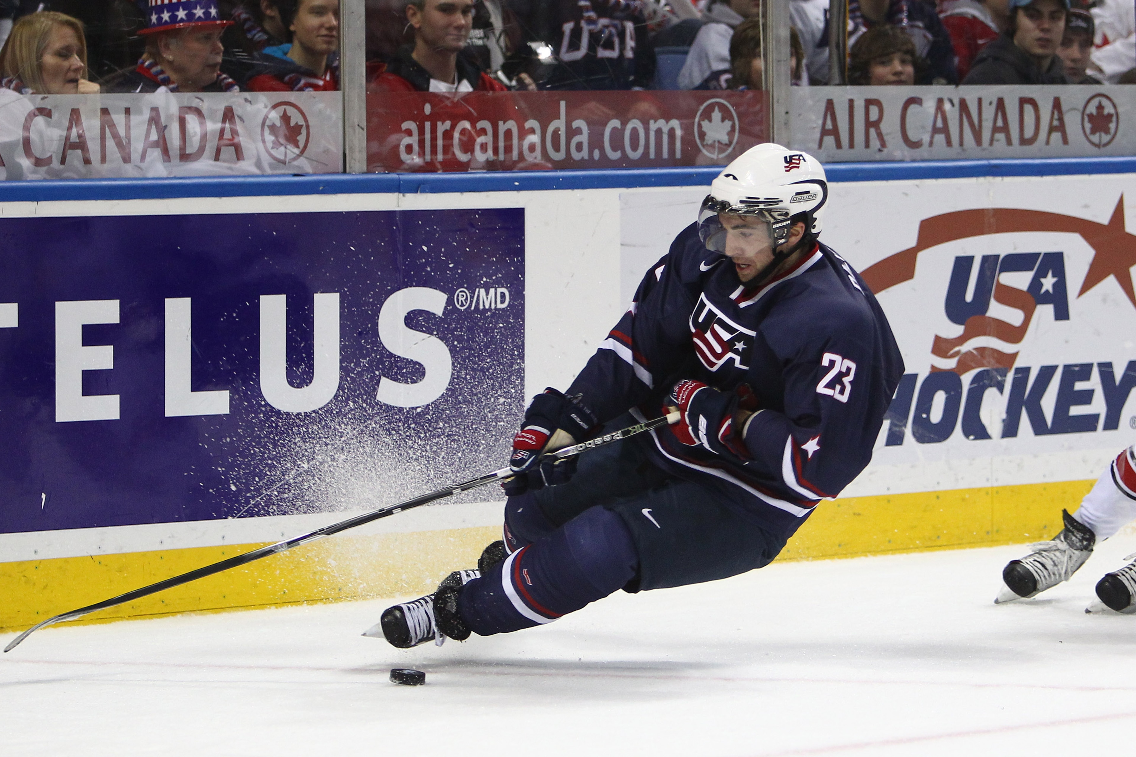 BUFFALO, NY - DECEMBER 31: Forward Kyle Palmieri #23 of USA loses his footing and falls during the 2011 IIHF World U20 Championship game between USA and Switzerland on December 31, 2010 at HSBC Arena in Buffalo, New York. (Photo by Tom Szczerbowski/Getty
