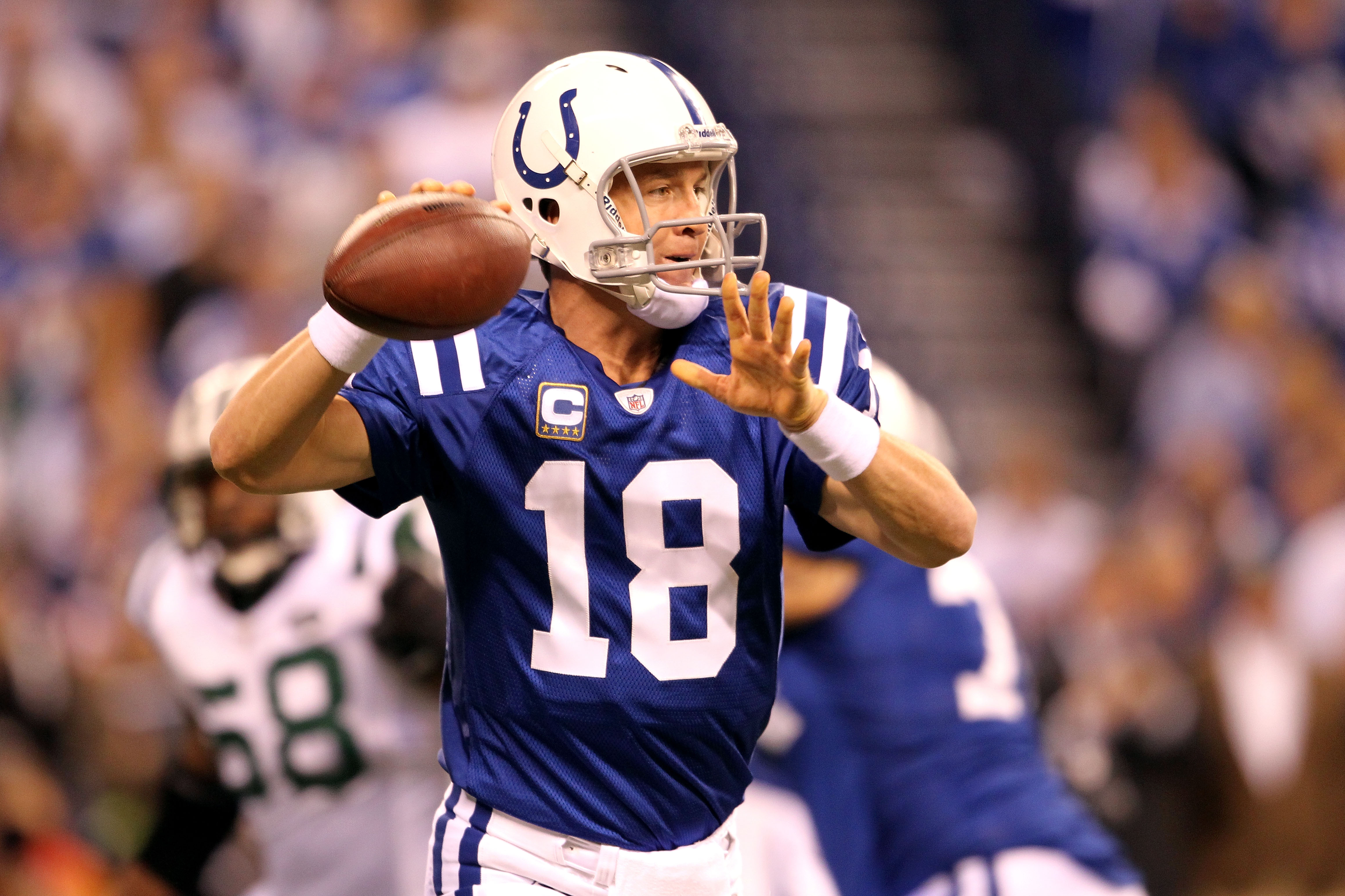 INDIANAPOLIS, IN - JANUARY 08:  Quarterback Peyton Manning #18 of the Indianapolis Colts passes the ball in the first quarter against the New York Jets during their 2011 AFC wild card playoff game at Lucas Oil Stadium on January 8, 2011 in Indianapolis, I