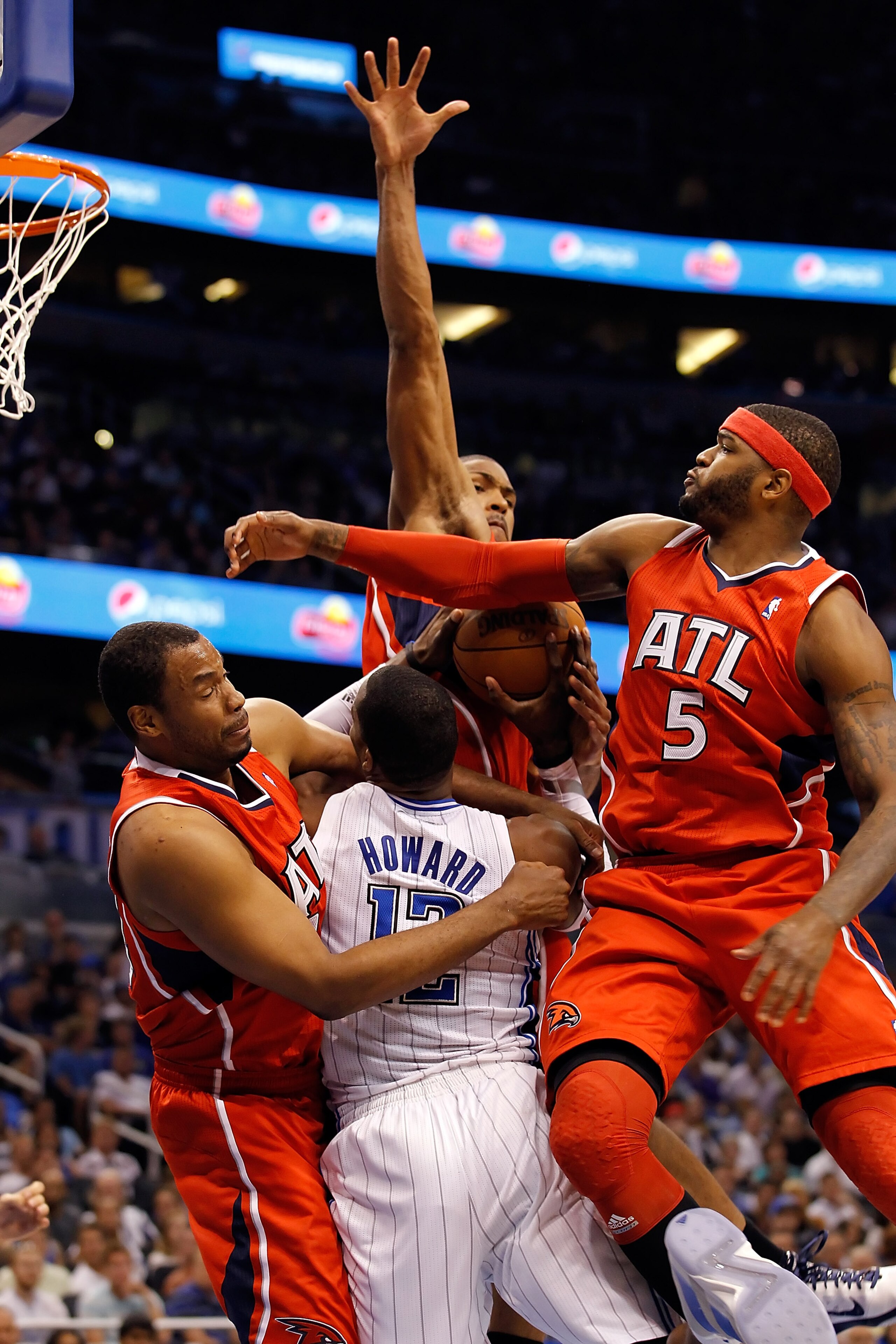 ORLANDO, FL - APRIL 16:  Jason Collins #34 (left), Al Horford #15 (center) and Josh Smith #5 of the Atlanta Hawks defend Dwight Howard #12 of the Orlando Magic during Game One of the Eastern Conference Quarterfinals of the 2011 NBA Playoffs on April 16, 2