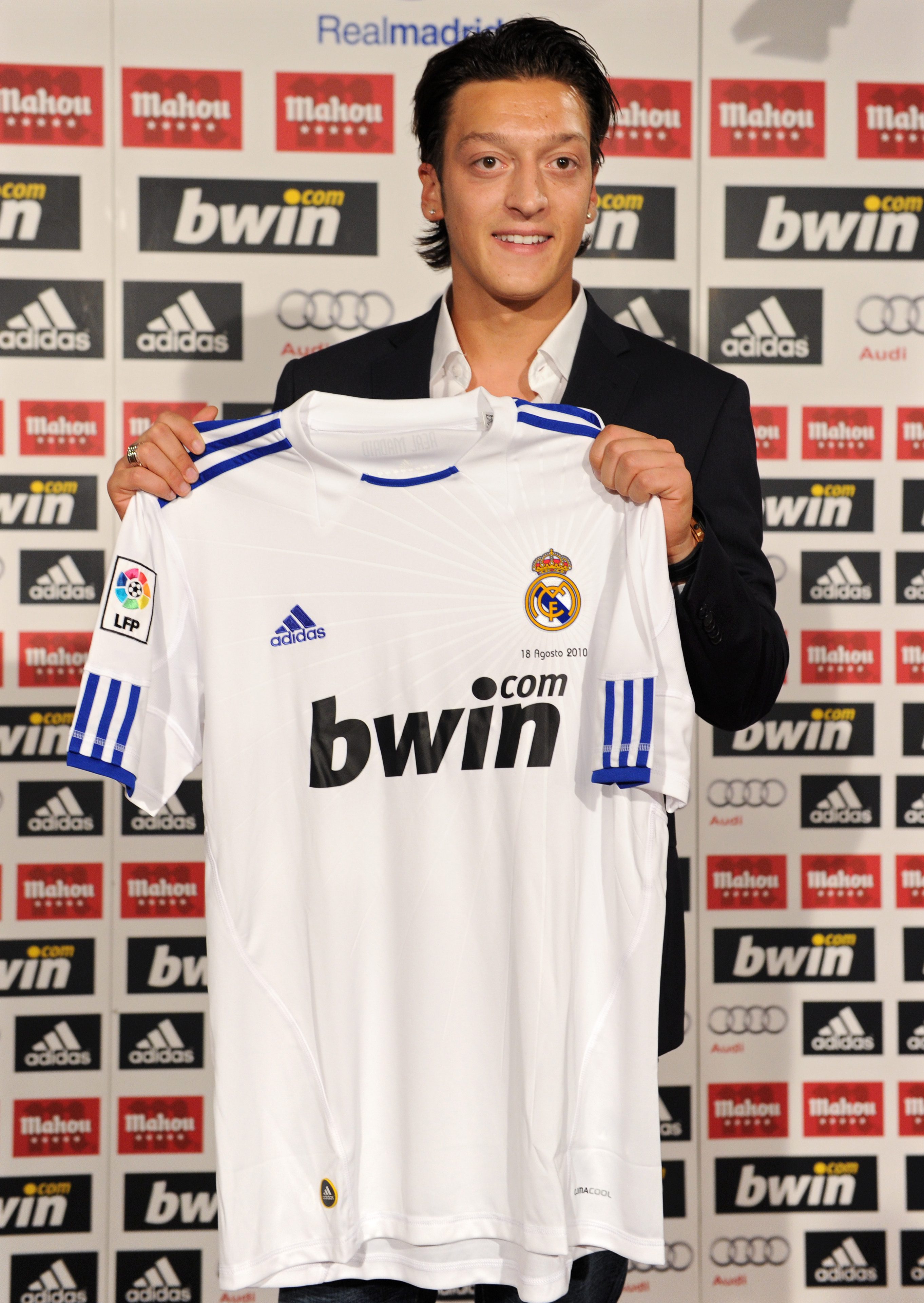 MADRID, SPAIN - AUGUST 18:  New signing Mesut Ozil poses with a Real Madrid shirt during his presentation as new Real Madrid player at the Estadio Santiago Bernabeu on August 18, 2010 in Madrid, Spain.  (Photo by Jasper Juinen/Getty Images)