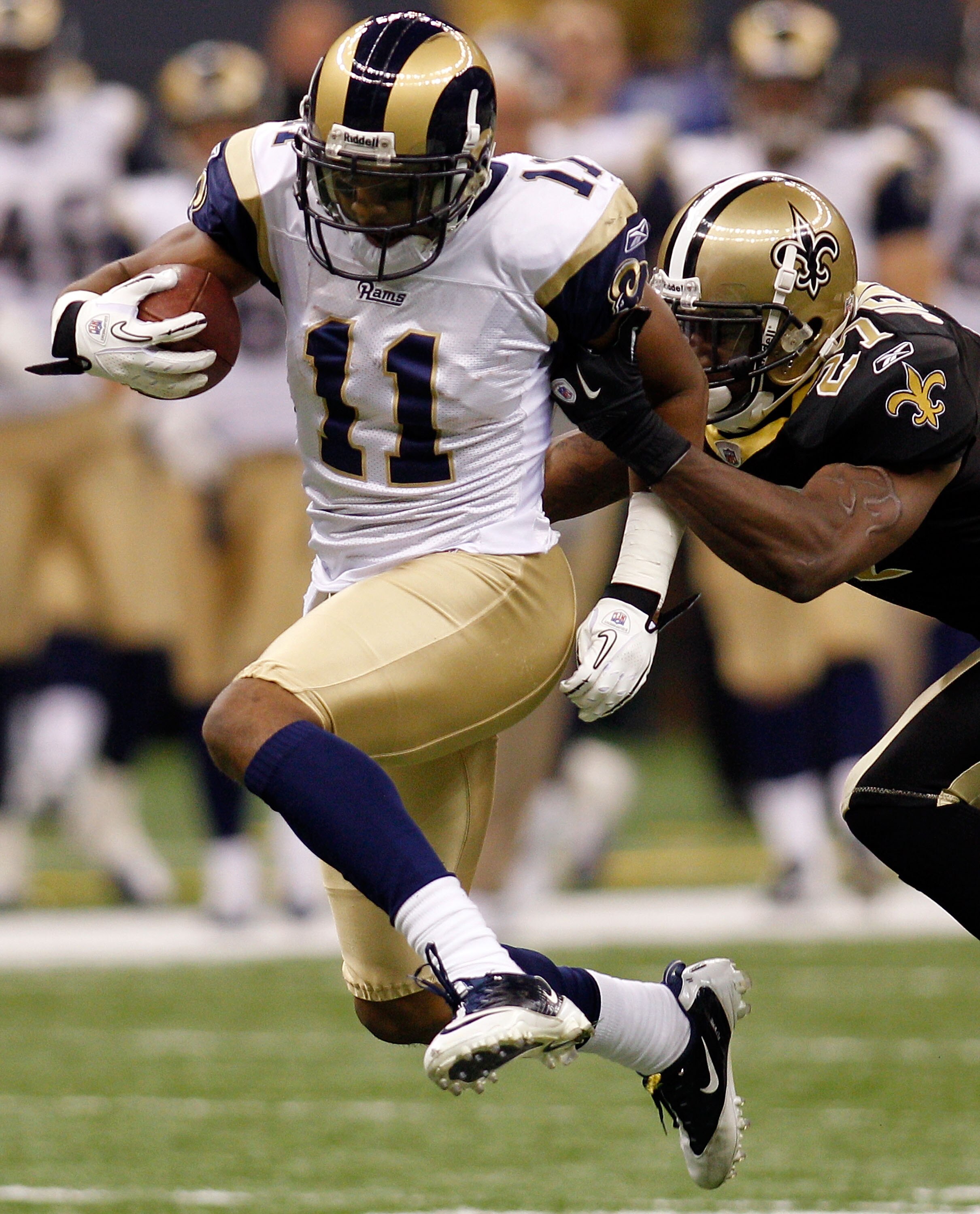 NEW ORLEANS, LA - DECEMBER 12:  Brandon Gibson #11 of the St. Louis Rams is tackled by Malcom Jenkins #27 of the New Orleans Saints at the Louisiana Superdome on December 12, 2010 in New Orleans, Louisiana.  (Photo by Chris Graythen/Getty Images)