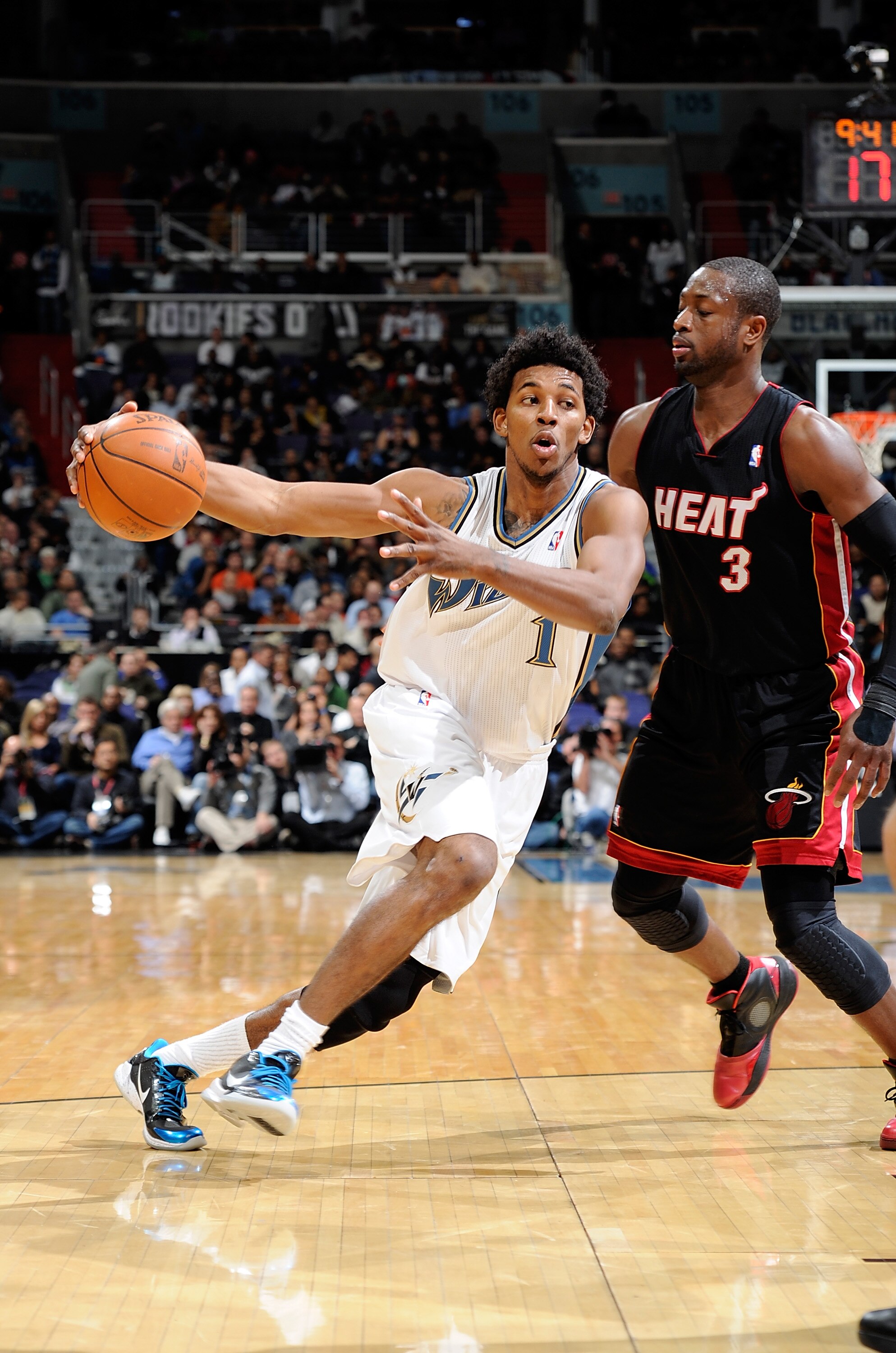 WASHINGTON - DECEMBER 18:  Nick Young #1 of the Washington Wizards drives to the hoop against Dwyane Wade #3 of the Miami Heat at the Verizon Center on December 18, 2010 in Washington, DC. NOTE TO USER: User expressly acknowledges and agrees that, by down