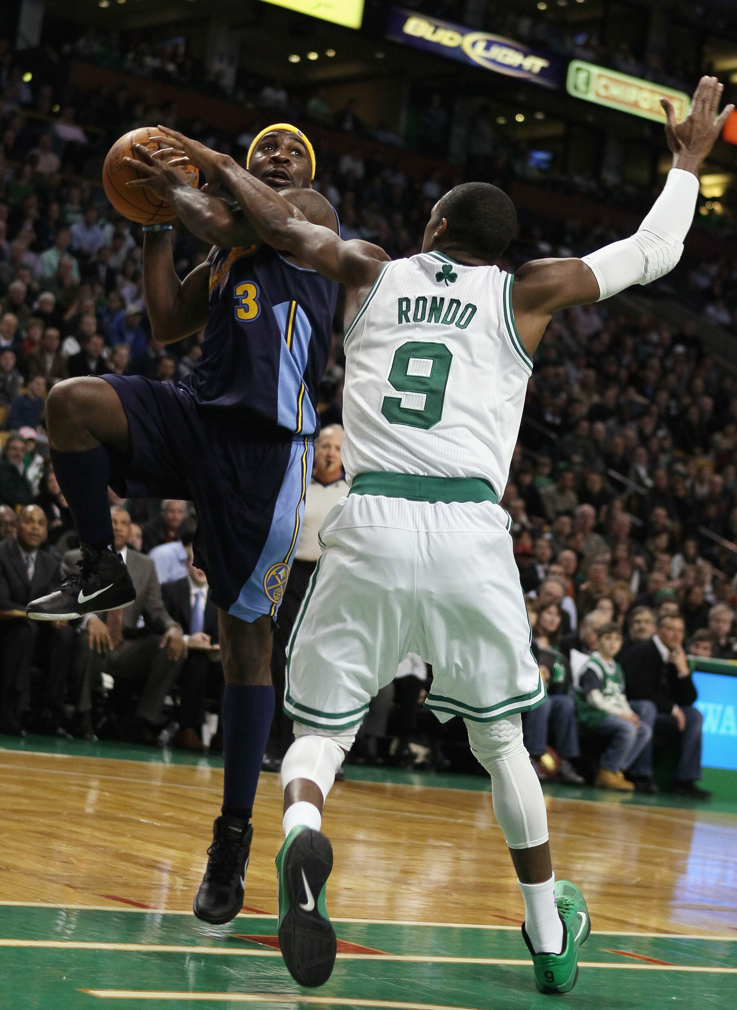 BOSTON, MA - DECEMBER 08:  Ty Lawson #3 of the Denver Nuggets heads for the basket as Rajon Rondo #9 of the Boston Celtics defends on December 8, 2010 at the TD Garden in Boston, Massachusetts. The Celtics defeated the Nuggets 105-89. NOTE TO USER: User e