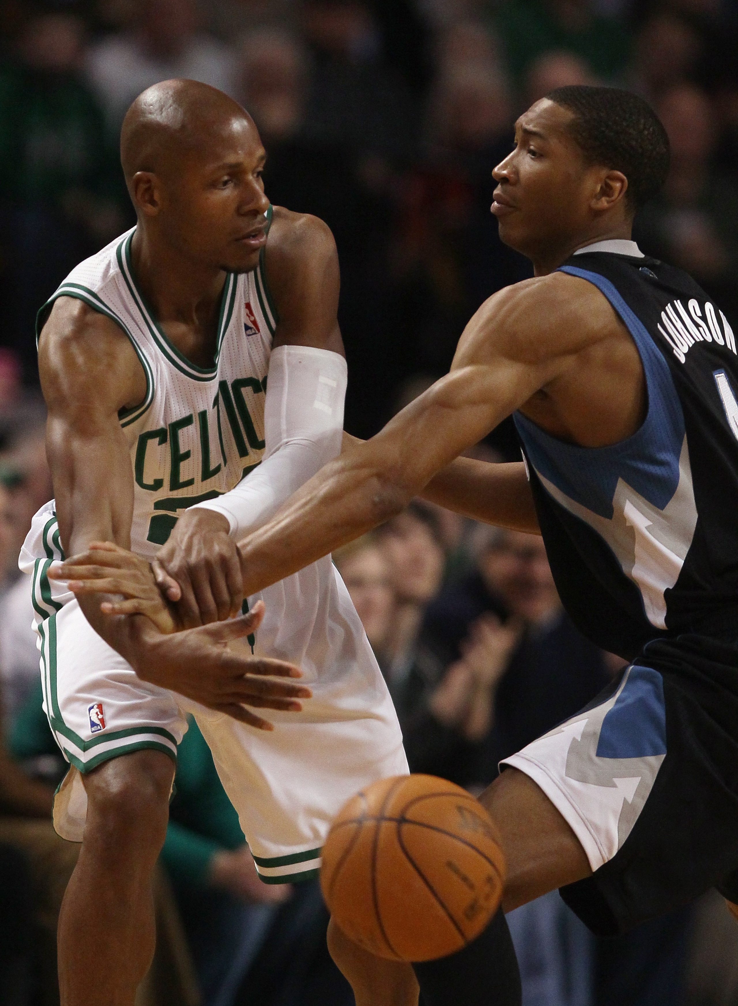 BOSTON, MA - JANUARY 03:  Ray Allen #20 of the Boston Celtics passes the ball under pressure from Wesley Johnson #4 of the Minnesota Timberwolves on January 3, 2011 at the TD Garden in Boston, Massachusetts. NOTE TO USER: User expressly acknowledges and a
