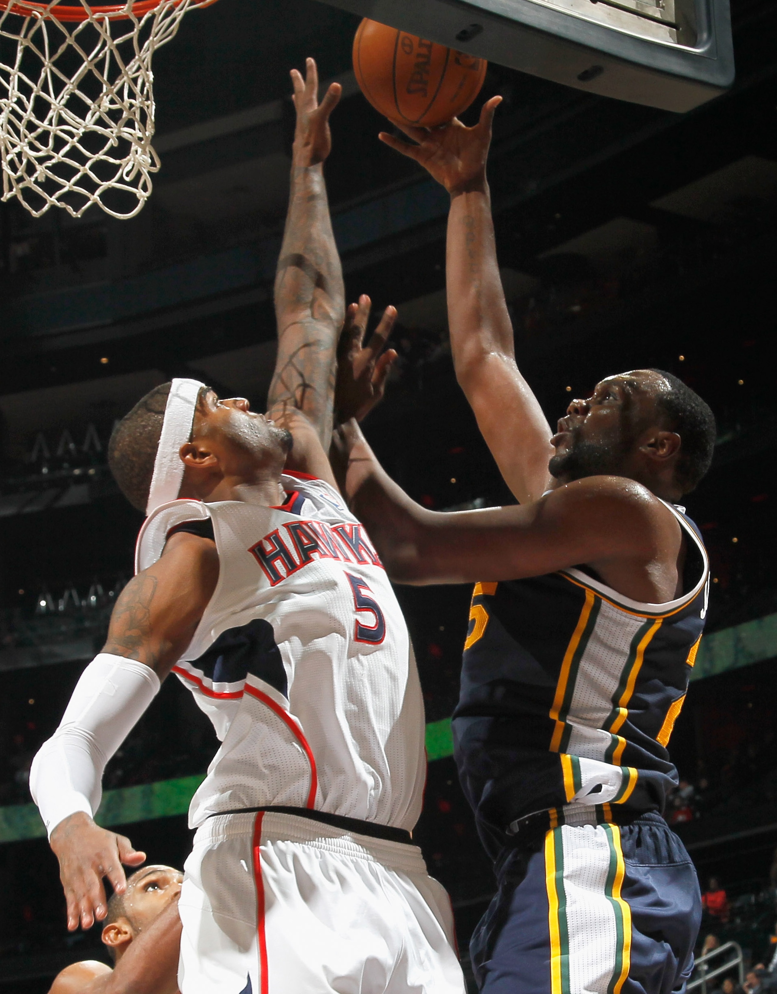 ATLANTA - NOVEMBER 12:  Josh Smith #5 of the Atlanta Hawks defends the basket against Al Jefferson #25 of the Utah Jazz at Philips Arena on November 12, 2010 in Atlanta, Georgia.  NOTE TO USER: User expressly acknowledges and agrees that, by downloading a
