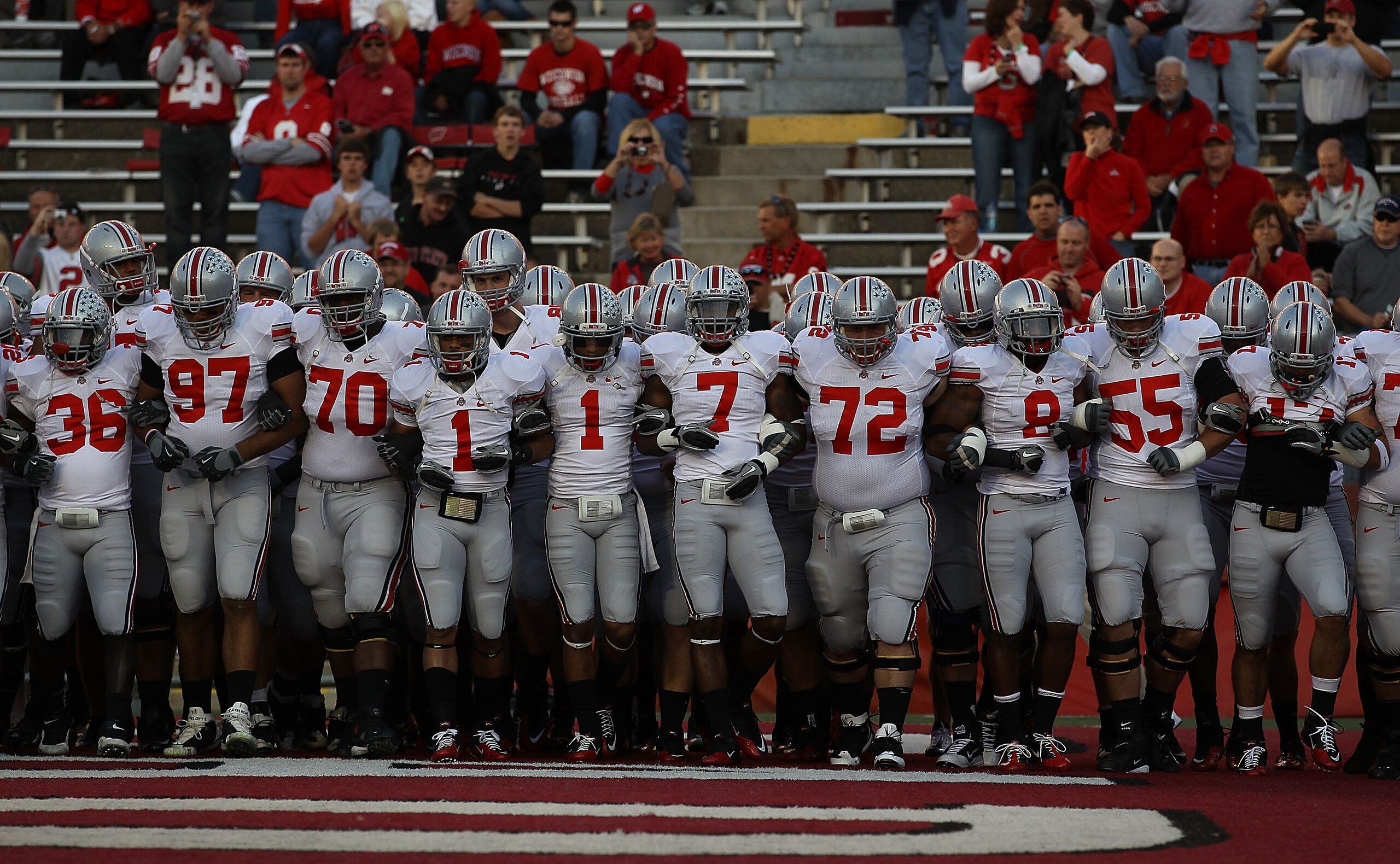 MADISON, WI - OCTOBER 16: Members of the Ohio State Buckeyes including Devon Torrence #1, Jermale Hines #7, Dexter Larimore #72 and Aaron Gant #8 walk on to the field for warm-ups before a game against the Wisconsin Badgers at Camp Randall Stadium on Octo