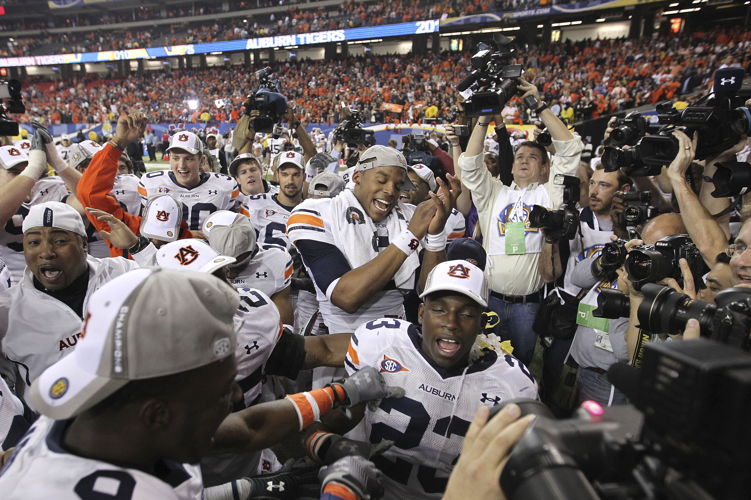 ATLANTA - DECEMBER 4:  Quarterback Cam Newton #2 of the Auburn Tigers (center) celebrates with his teammates after the 2010 SEC Championship game against South Carolina Gamecocks at Georgia Dome on December 4, 2010 in Atlanta, Georgia. (Photo by Mike Zarr
