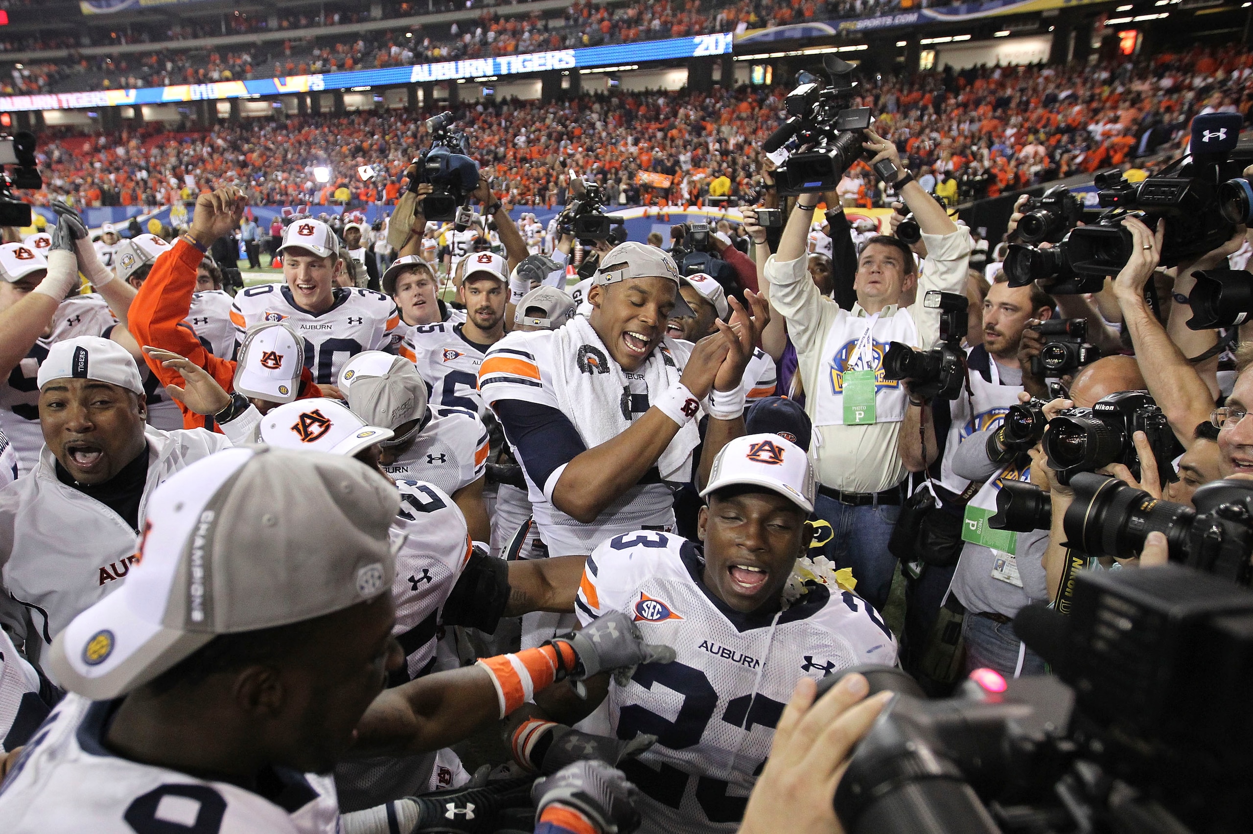 ATLANTA - DECEMBER 4:  Quarterback Cam Newton #2 of the Auburn Tigers (center) celebrates with his teammates after the 2010 SEC Championship game against South Carolina Gamecocks at Georgia Dome on December 4, 2010 in Atlanta, Georgia. (Photo by Mike Zarr