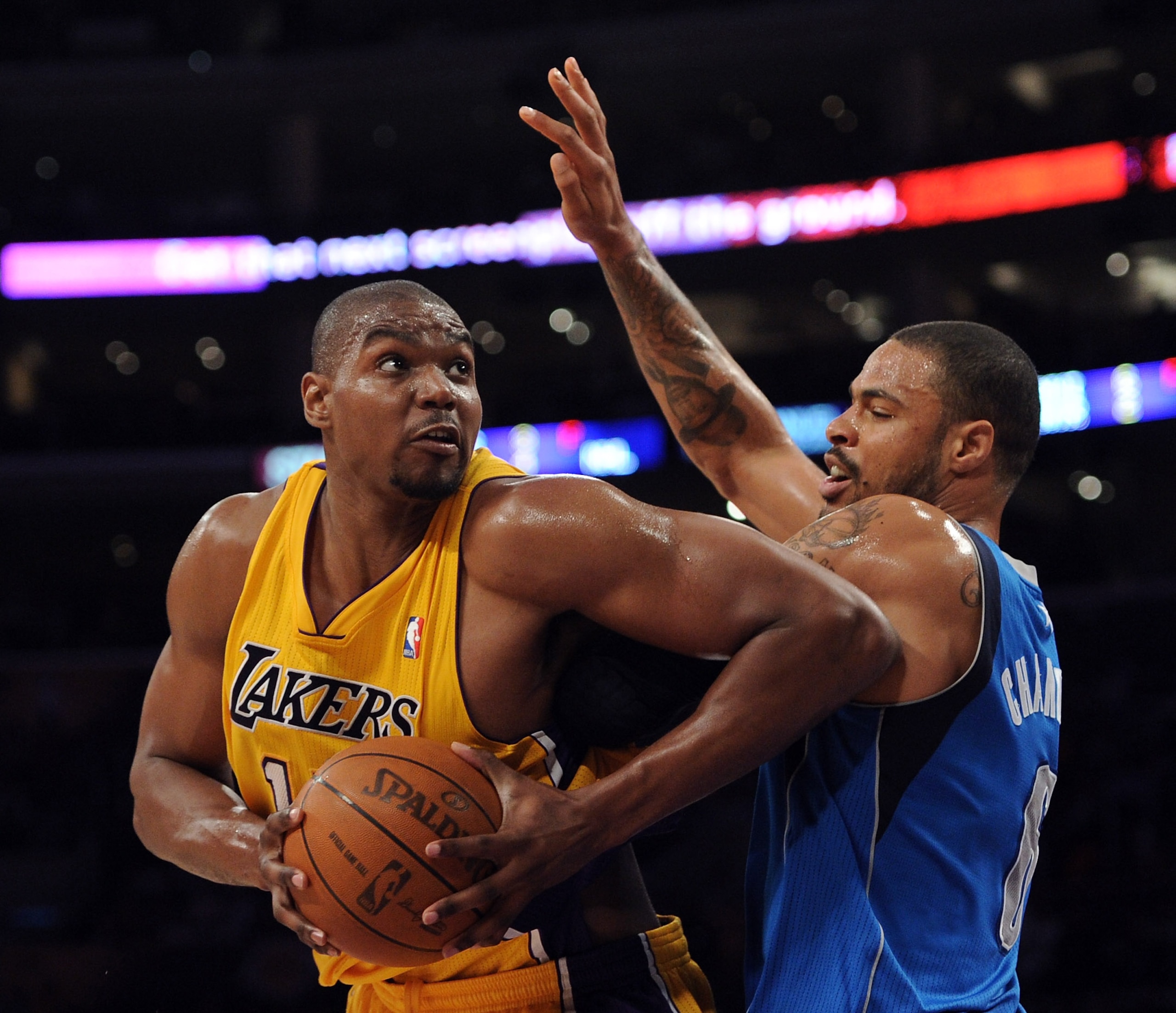 LOS ANGELES, CA - MARCH 31:  Andrew Bynum #17 of the Los Angeles Lakers turns from the defense of Tyson Chandler #6 of the Dallas Mavericks at Staples Center on March 31, 2011 in Los Angeles, California.  NOTE TO USER: User expressly acknowledges and agre