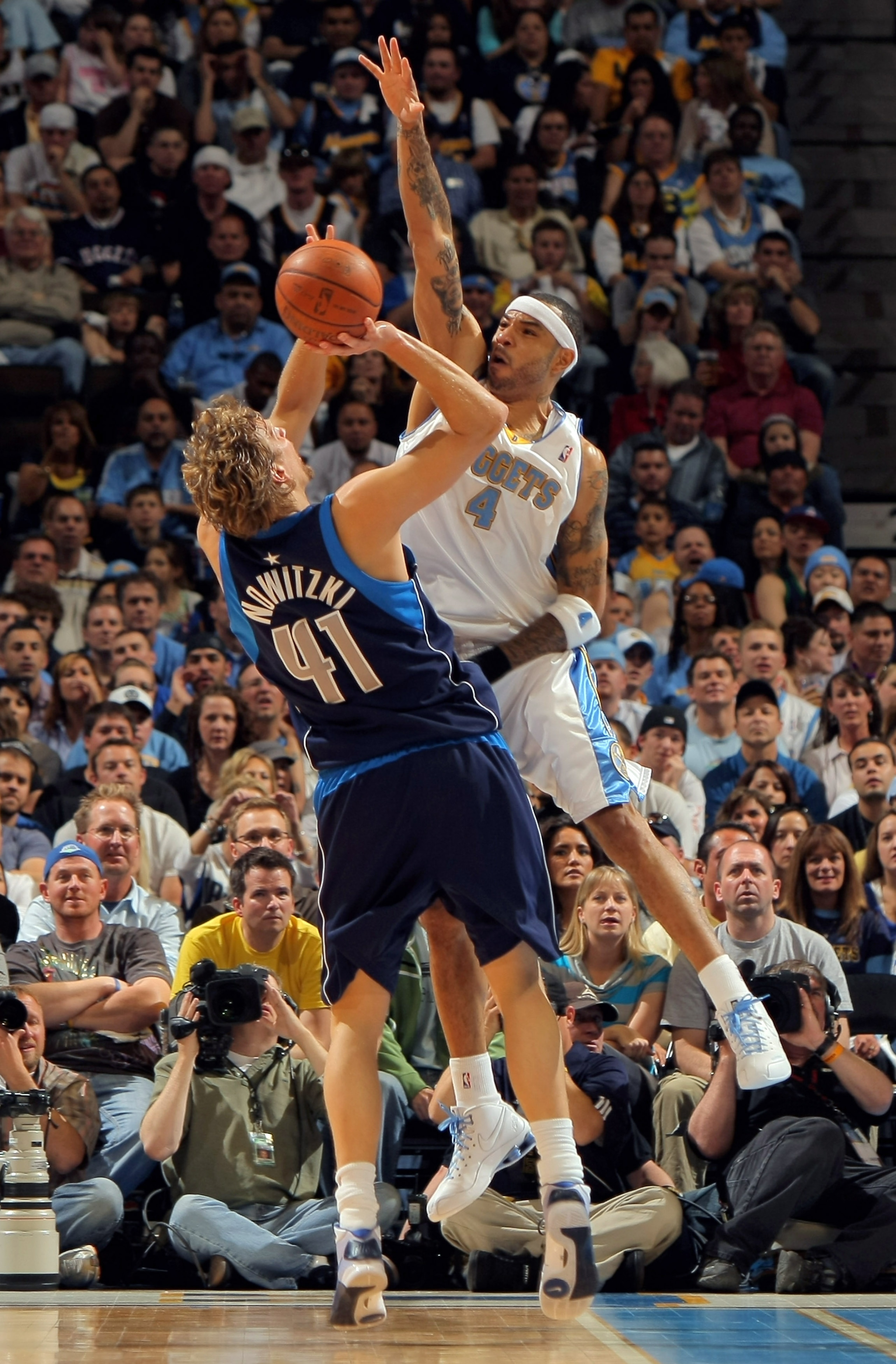 DENVER - MAY 03:  Kenyon Martin #4 of the Denver Nuggets goes up to block a shot by Dirk Nowitzki #41 of the Dallas Mavericks in Game One of the Western Conference Semifinals during the 2009 NBA Playoffs at Pepsi Center on May 3, 2009 in Denver, Colorado.
