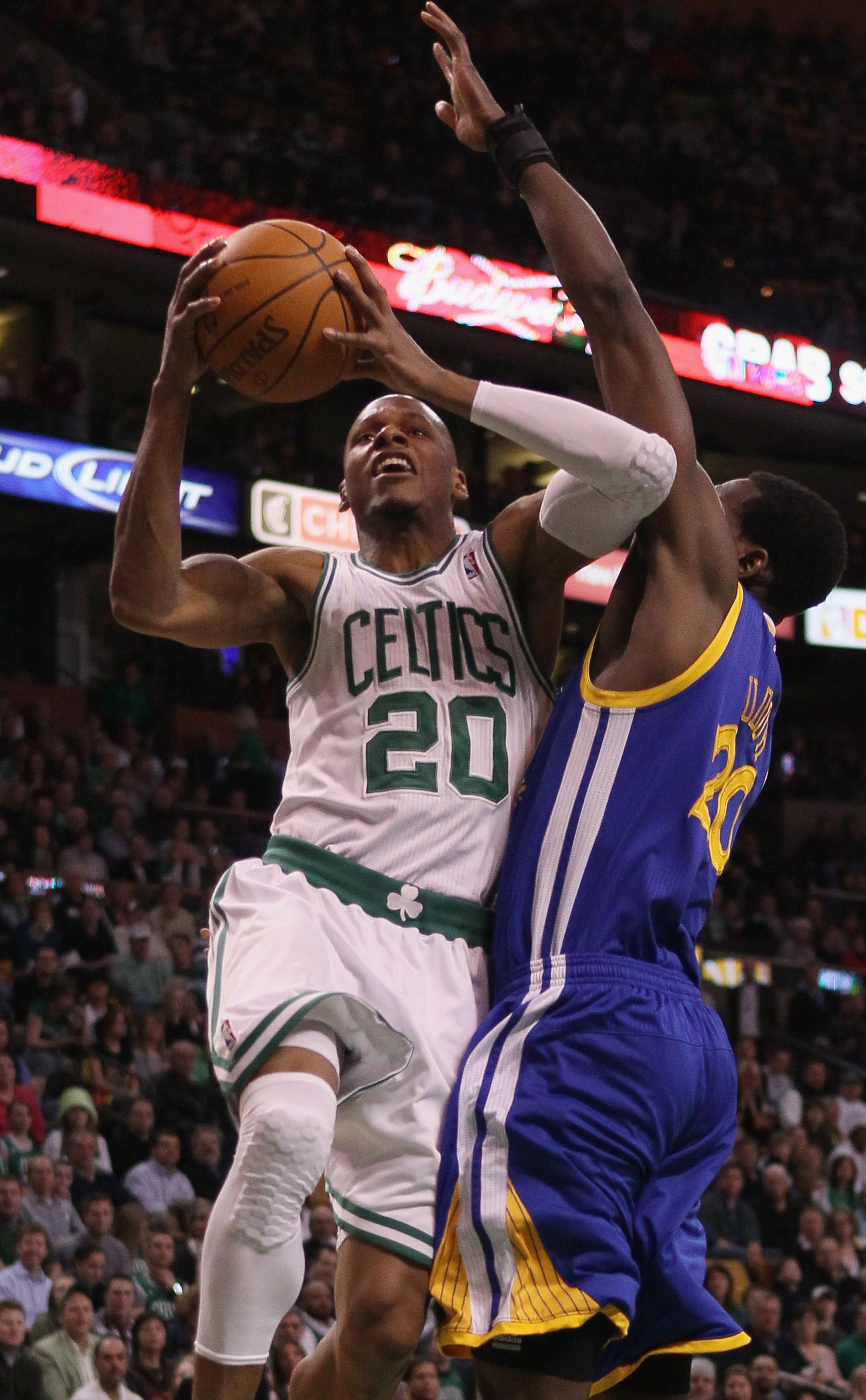 BOSTON, MA - MARCH 04:  Ray Allen #20 of the Boston Celtics takes a shot as Ekpe Udoh #20 of the Golden State Warriors defends on March 4, 2011 at the TD Garden in Boston, Massachusetts.  NOTE TO USER: User expressly acknowledges and agrees that, by downl