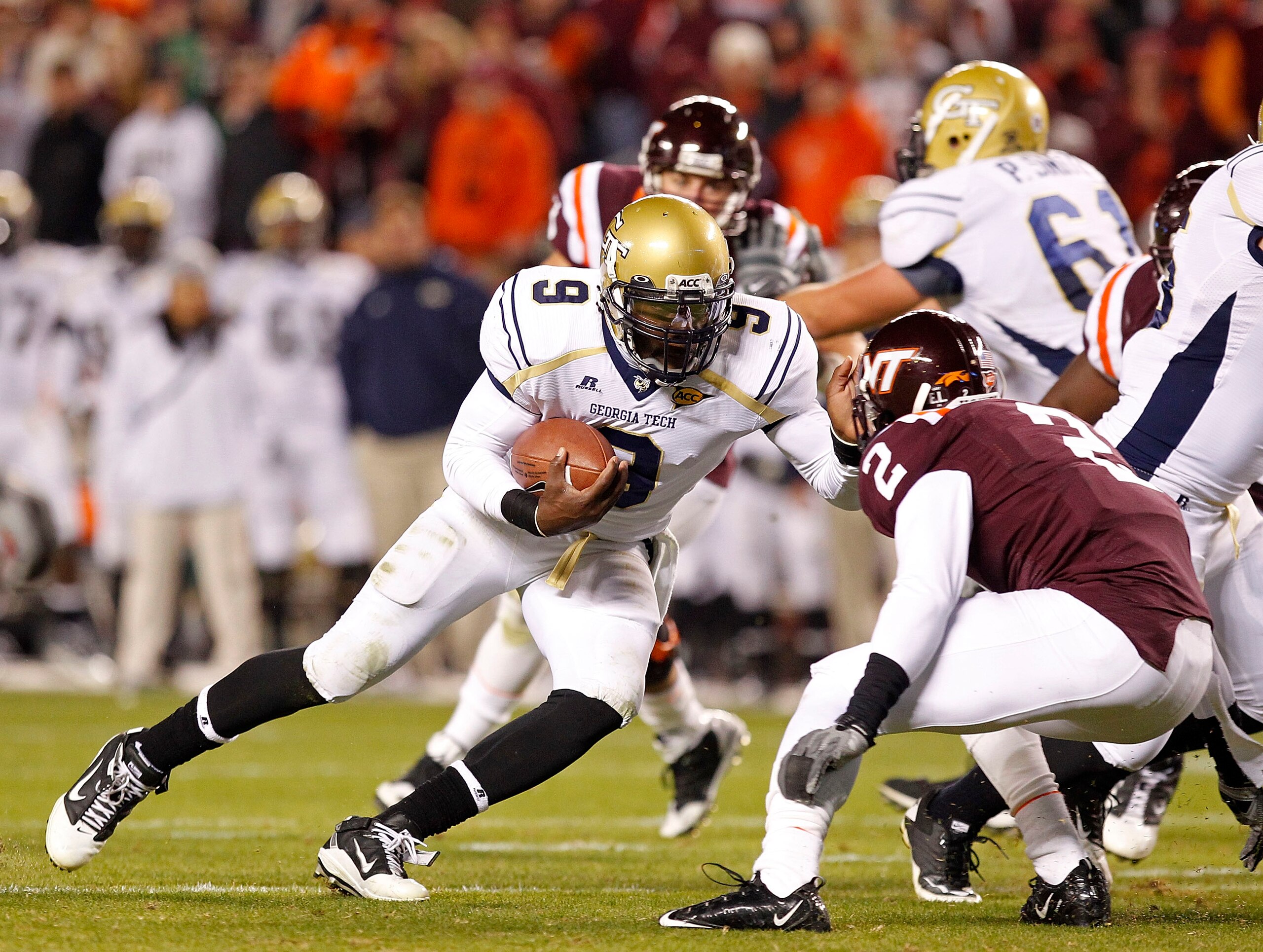 BLACKSBURG, VA - NOVEMBER 04: Quarterback Joshua Nesbitt #9 of the Georgia Tech Yellow Jackets runs with the ball as linebacker Davon Morgan #2 of the Virginia Tech Hokies defends at Lane Stadium on November 4, 2010 in Blacksburg, Virginia.  (Photo by Geo