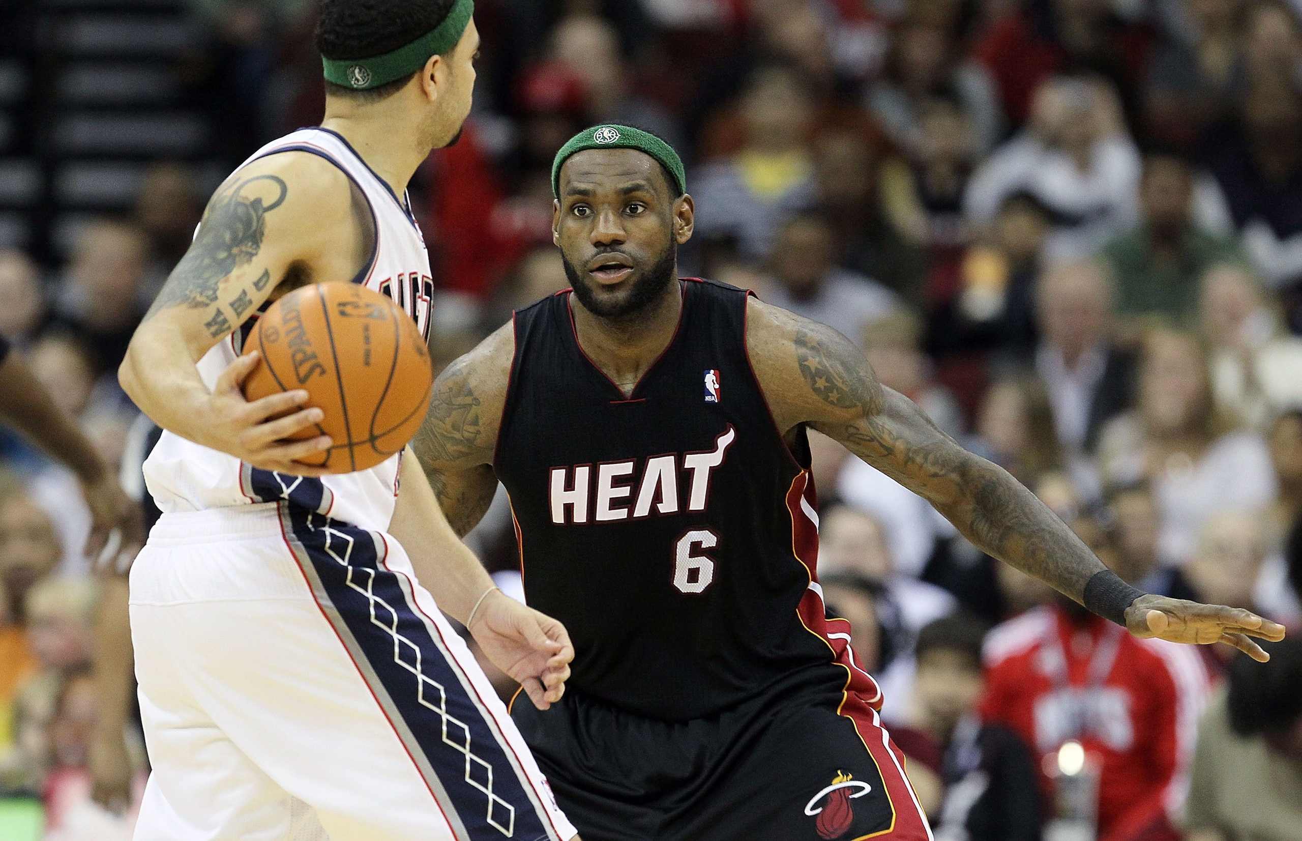 NEWARK, NJ - APRIL 03:  LeBron James #6 of the Miami Heat defends against Deron Williams #8 of the New Jersey Nets at the Prudential Center on April 3, 2011 in Newark, New Jersey.The Heat defeated the Nets 108-94.NOTE TO USER: User expressly acknowledges