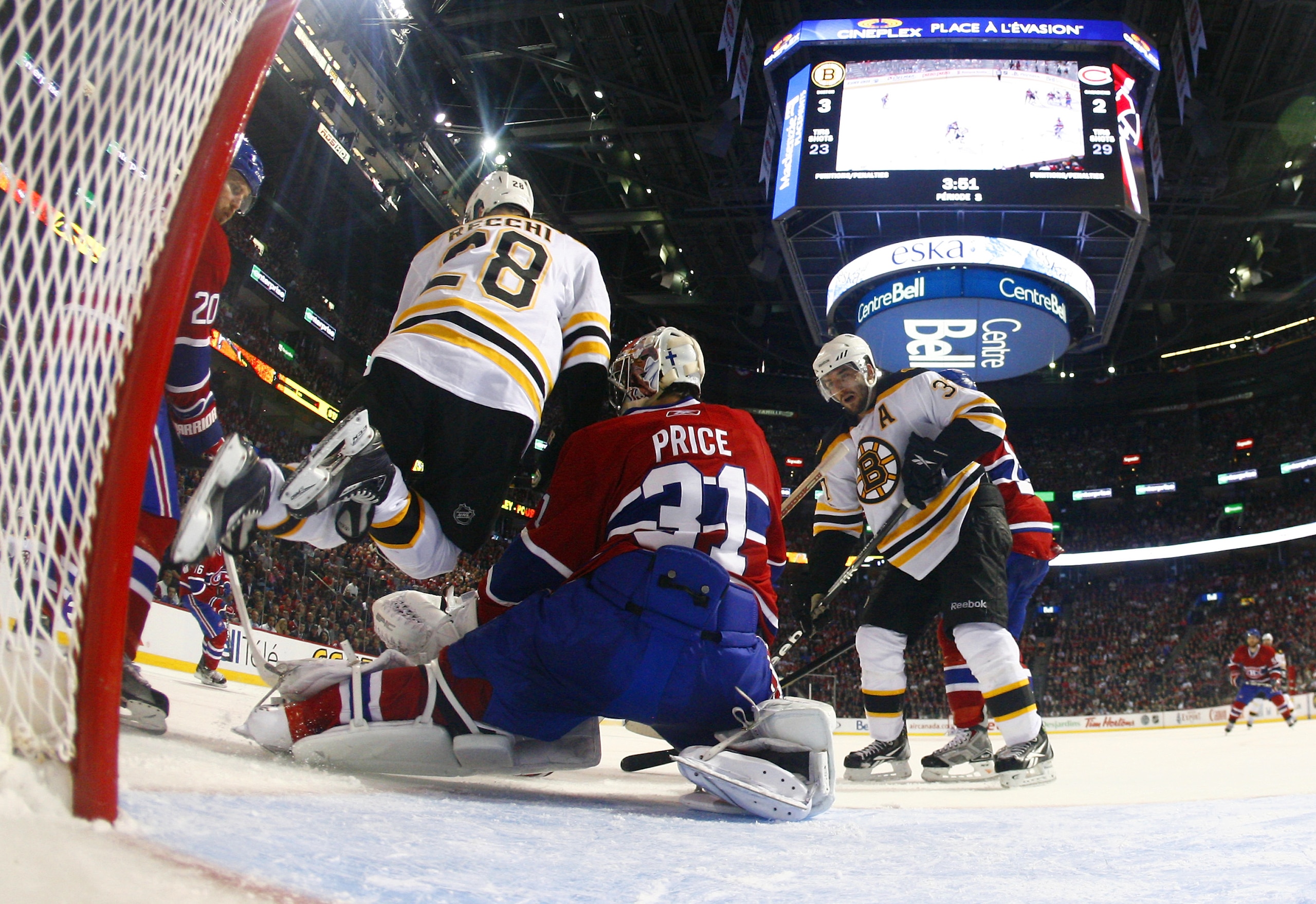 MONTREAL, QC - APRIL 18: Carey Price #31 of the Montreal Canadiens makes a pad save down low with Mark Recchi #28 of the Boston Bruins running interference at the top of the crease in Game Three of the Eastern Conference Quarterfinals during the 2011 NHL MONTREAL, QC - APRIL 18: Carey Price #31 of the Montreal Canadiens makes a pad save down low with Mark Recchi #28 of the Boston Bruins running interference at the top of the crease in Game Three of the Eastern Conference Quarterfinals during the 2011 NHL