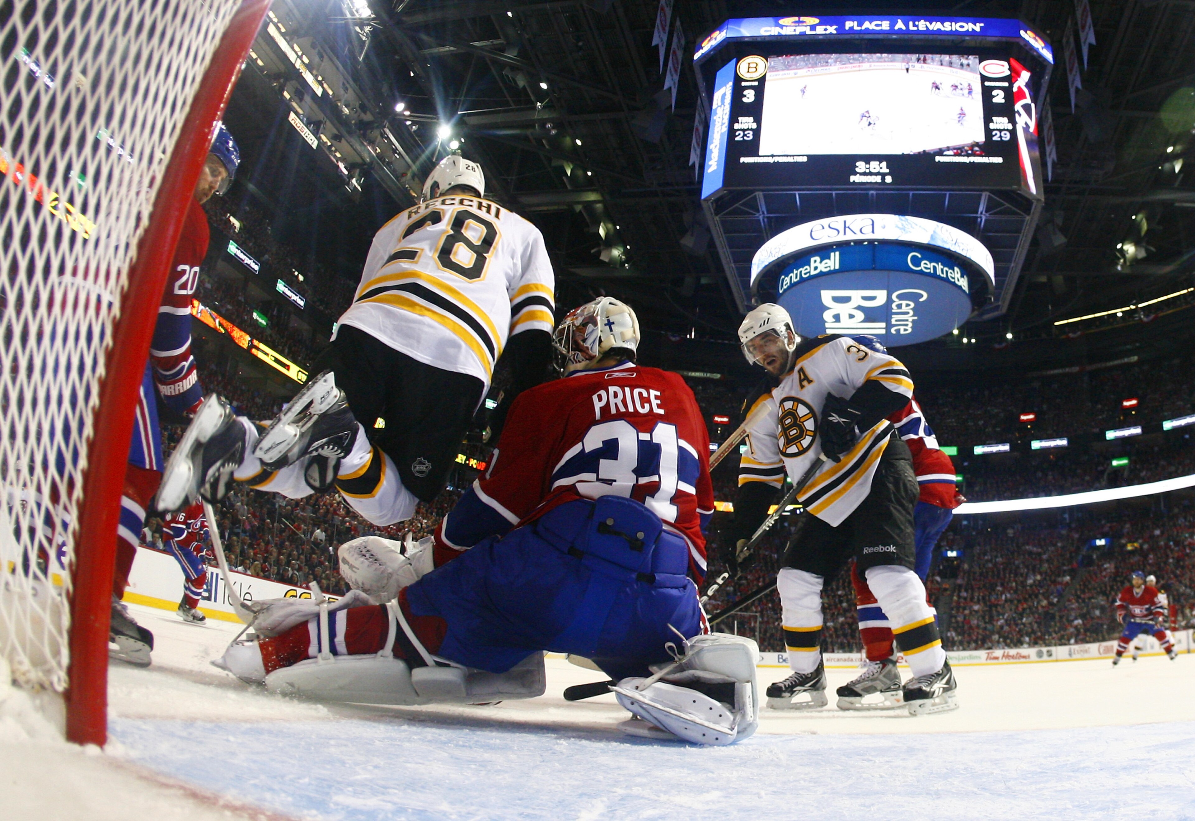 MONTREAL, QC - APRIL 18:  Carey Price #31 of the Montreal Canadiens makes a pad save down low with Mark Recchi #28 of the Boston Bruins running interference at the top of the crease in Game Three of the Eastern Conference Quarterfinals during the 2011 NHL