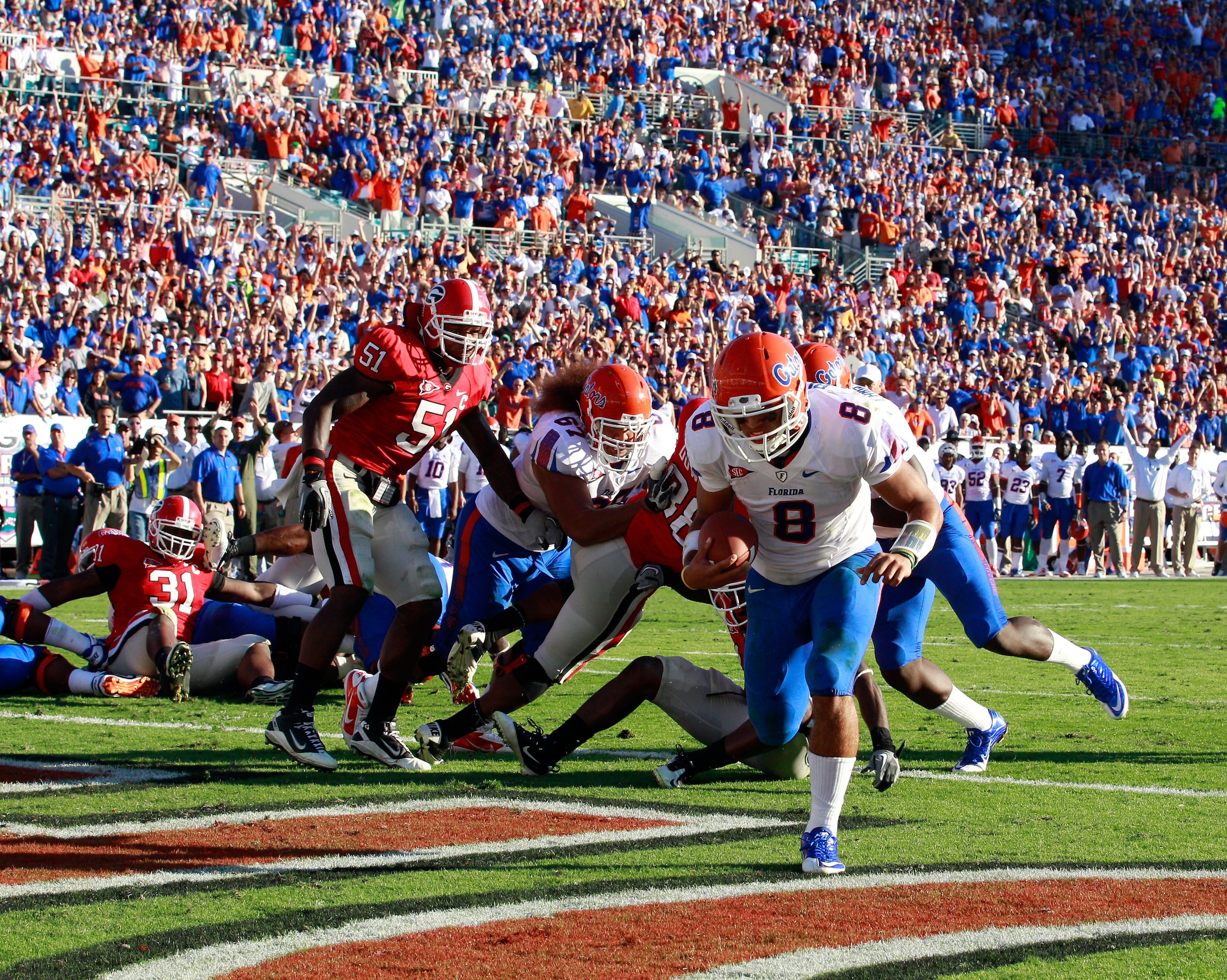 JACKSONVILLE, FL - OCTOBER 30:  Quarterback Trey Burton #8 of the Florida Gators runs for a touchdown during the game against the Georgia Bulldogs at EverBank Field on October 30, 2010 in Jacksonville, Florida.  (Photo by Sam Greenwood/Getty Images)