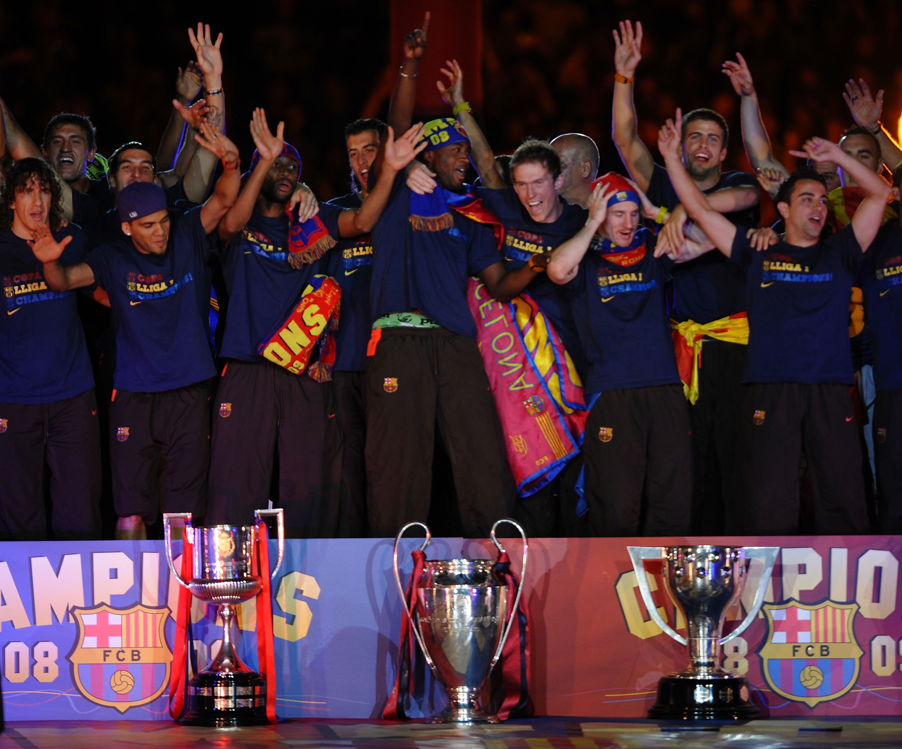BARCELONA, SPAIN - MAY 28: Barcelona players celebrate beside their three thophys, Copa del Rey (L), UEFA Champions League and La Liga at the Nou Camp Stadium the day after Barcelona won the UEFA Champions League Cup final on May 28, 2009 in Barcelona, Sp