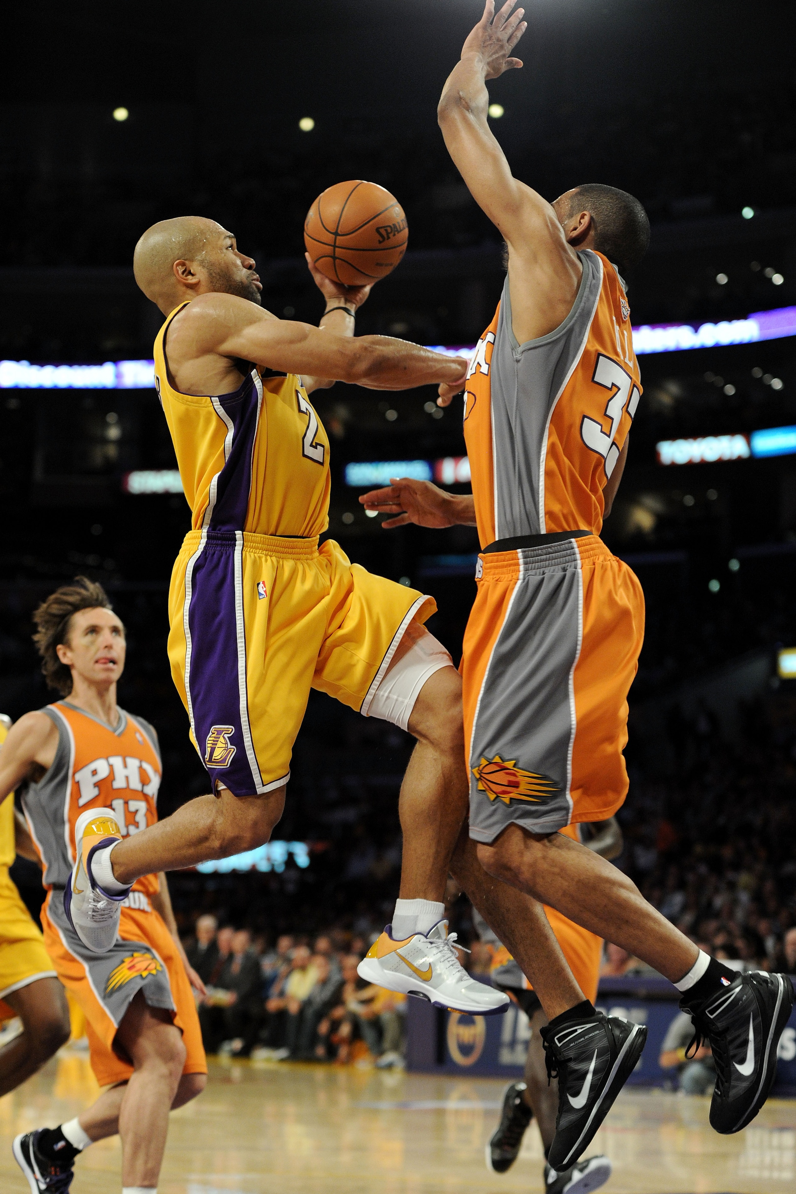 LOS ANGELES, CA - MAY 19:  Derek Fisher #2 of the Los Angeles Lakers goes up for a shot as Grant Hill #33 of the Phoenix Suns defends in the third quarter of Game Two of the Western Conference Finals during the 2010 NBA Playoffs at Staples Center on May 1