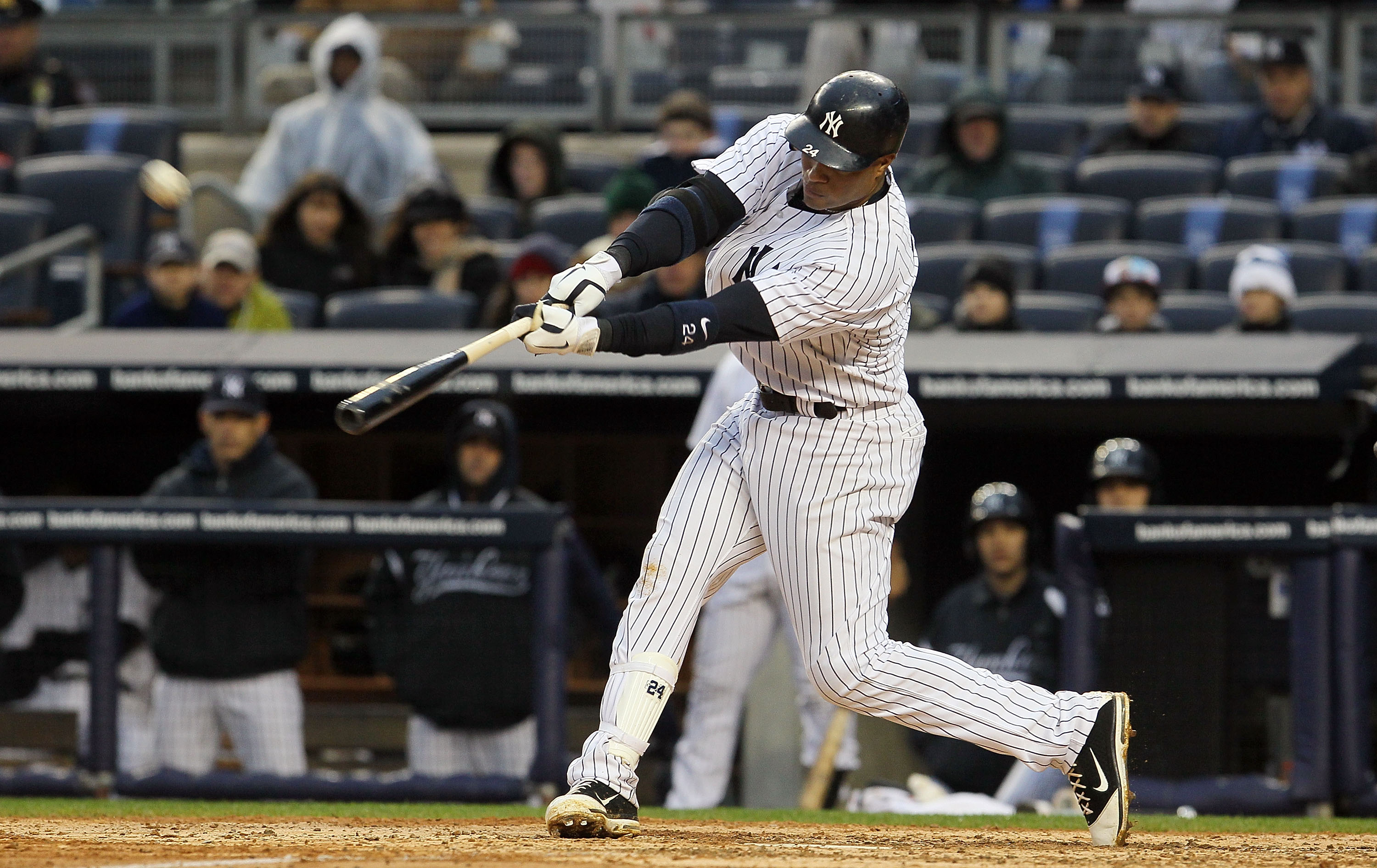 NEW YORK, NY - APRIL 16:  Robinson Cano #24 of the New York Yankees connects on a eighth-inning two-run home run against the Texas Rangers on April 16, 2011 at Yankee Stadium in the Bronx borough of New York City. The Yankees defeated the Rangers 5-2.  (P