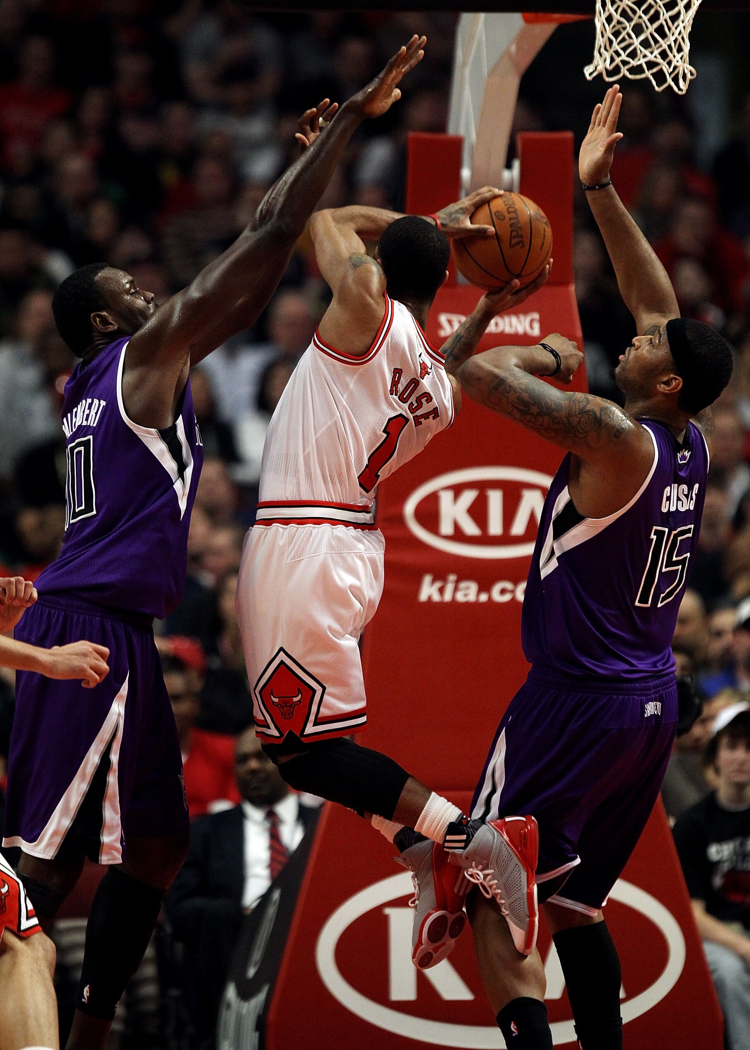 CHICAGO, IL - MARCH 21: Derrick Rose #1 of the Chicago Bulls puts up a shot between Samuel Dalembert #10 (L) and DeMarcus Cousins #15 of the Sacramento Kings at the United Center on March 21, 2011 in Chicago, Illinois. NOTE TO USER: User expressly acknowl