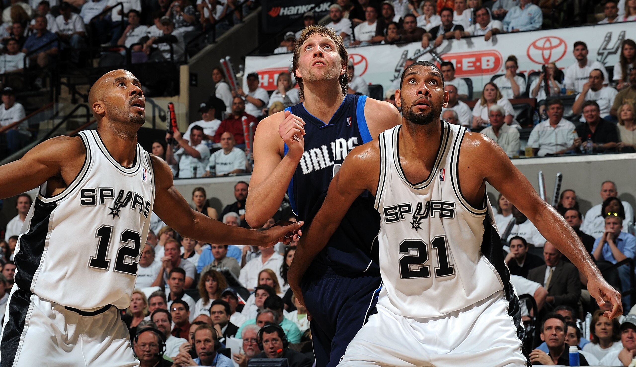 SAN ANTONIO - APRIL 20:  Forward Bruce Bowen #12 and Tim Duncan #21 of the San Antonio Spurs defend Dirk Nowitzki #41 of the Dallas Mavericks in Game Two of the Western Conference Quarterfinals during the 2009 NBA Playoffs at AT&T Center on April 20, 2009