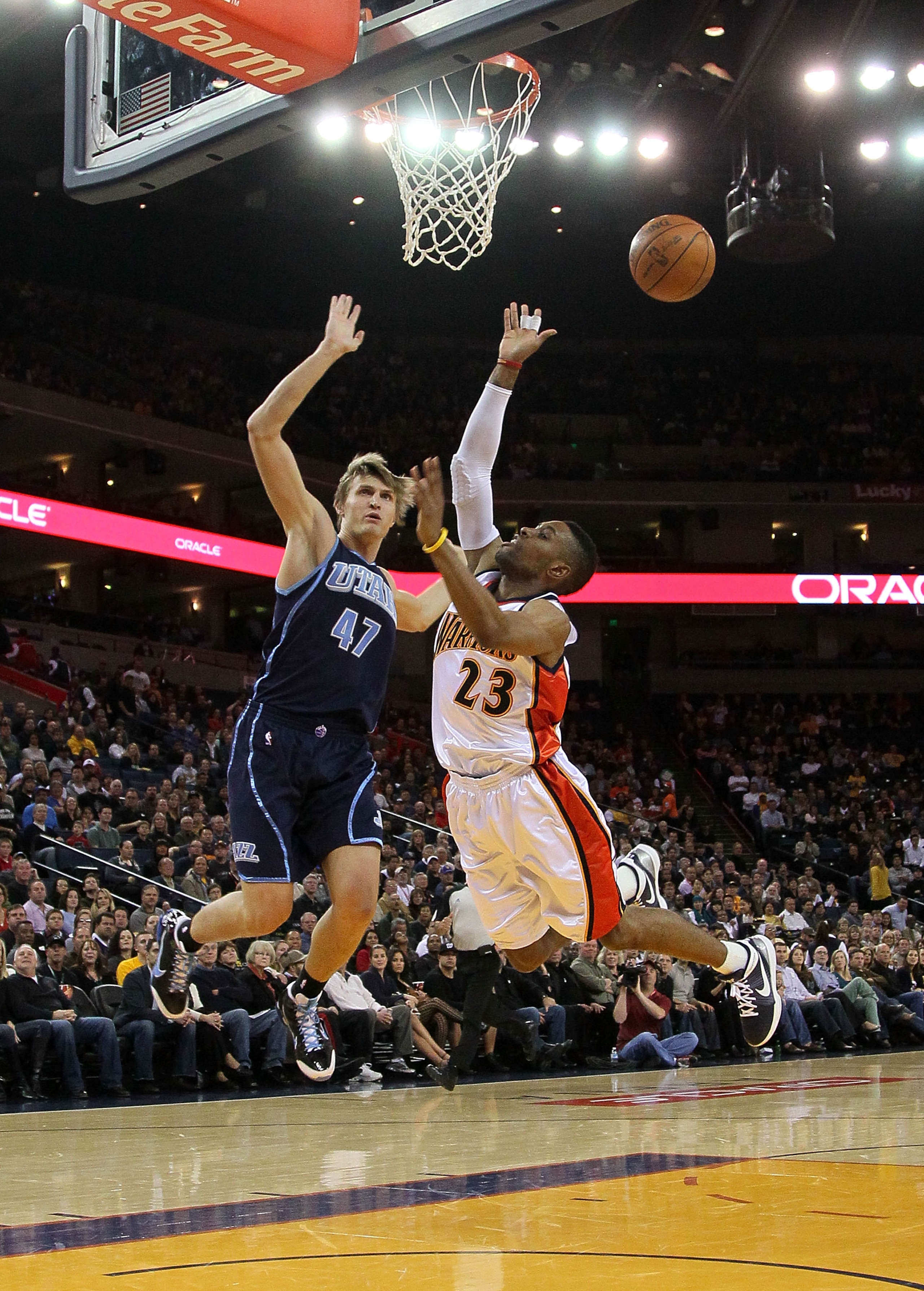 OAKLAND, CA - FEBRUARY 19:  Andrei Kirilenko #47 of the Utah Jazz defends against C.J. Watson #23 of the Golden State Warriors during an NBA game at Oracle Arena at Oracle Arena on February 19, 2010 in Oakland, California.  NOTE TO USER: User expressly ac
