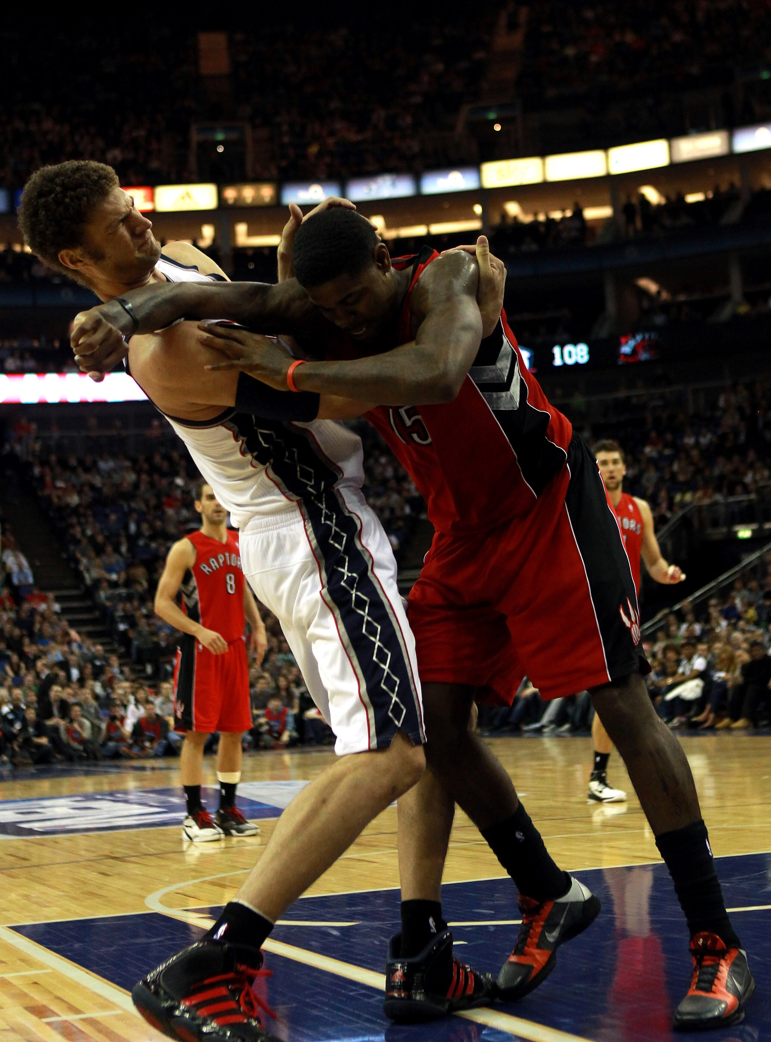 LONDON, ENGLAND - MARCH 04:  Tempers flare as Brook Lopez #11 of the Nets and Amir Johnson #15 of the Raptors clash during the NBA match between New Jersey Nets and the Toronto Raptors at the O2 Arena on March 4, 2011 in London, England. NOTE TO USER: Use